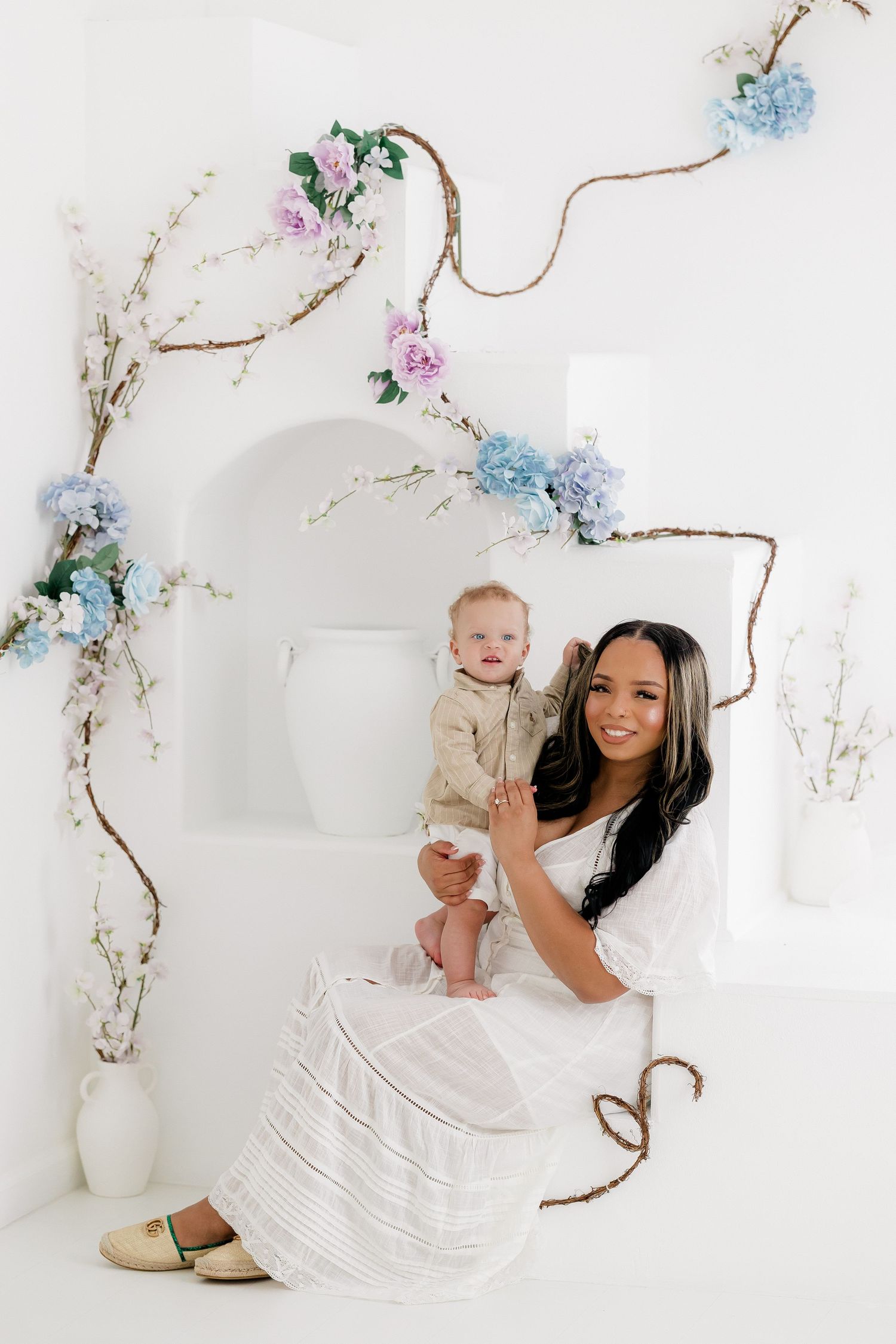 A series of artistic photos featuring white dresses and floral decorations against a light background.