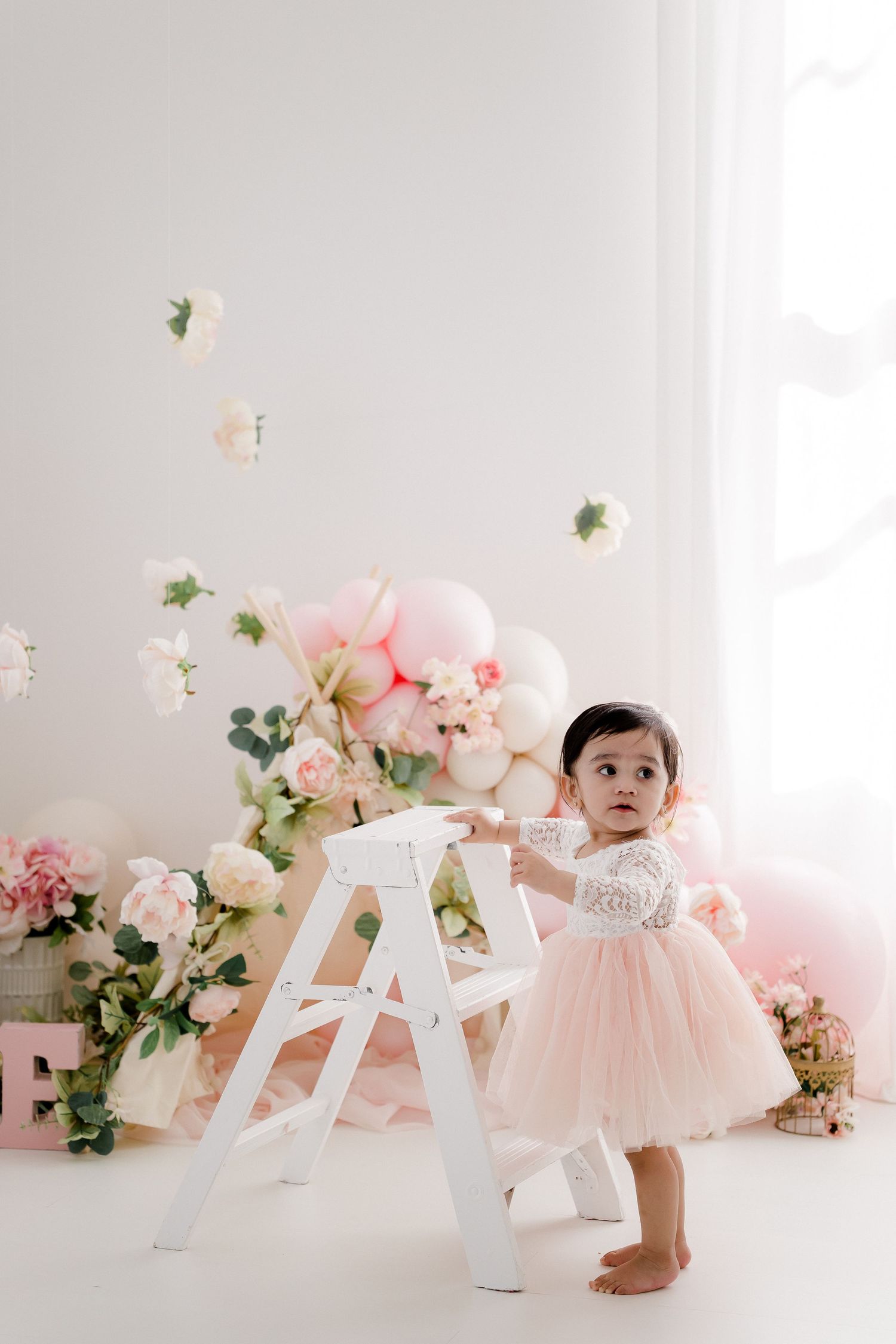 White decorative letters spell LOVE against pink floral backdrop.
