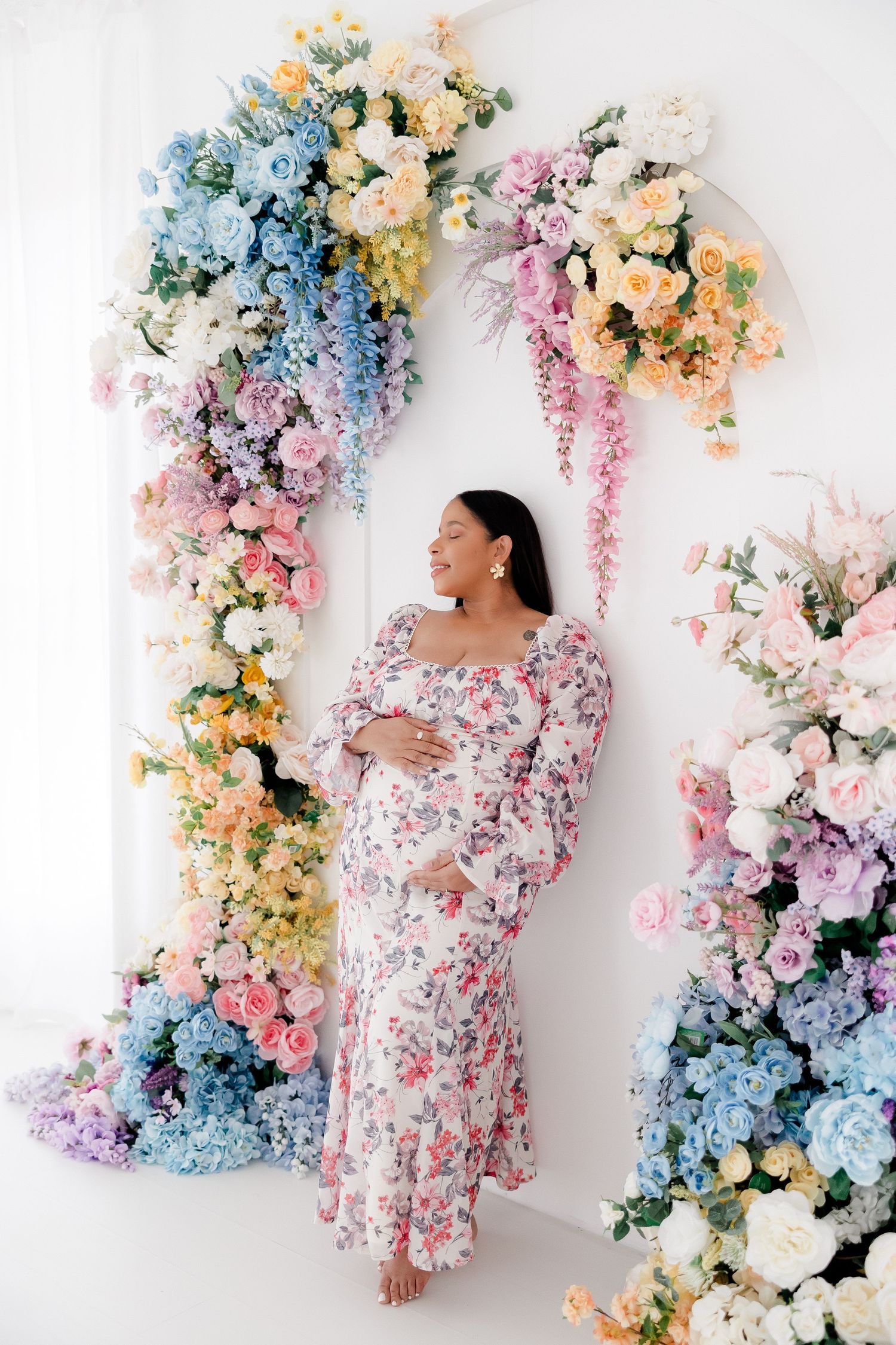 Floral backdrop with pastel roses, hydrangeas and wisteria creates dreamy setting for fashion photography.