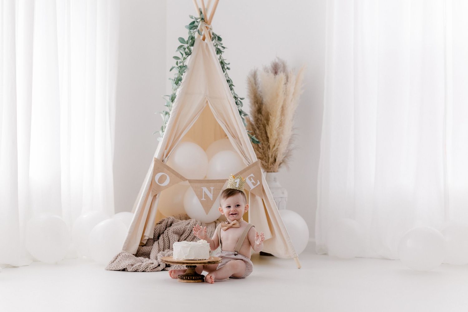 Boho-style children's playroom with teepee tents, soft cushions, and dreamy white curtains creating a cozy atmosphere.