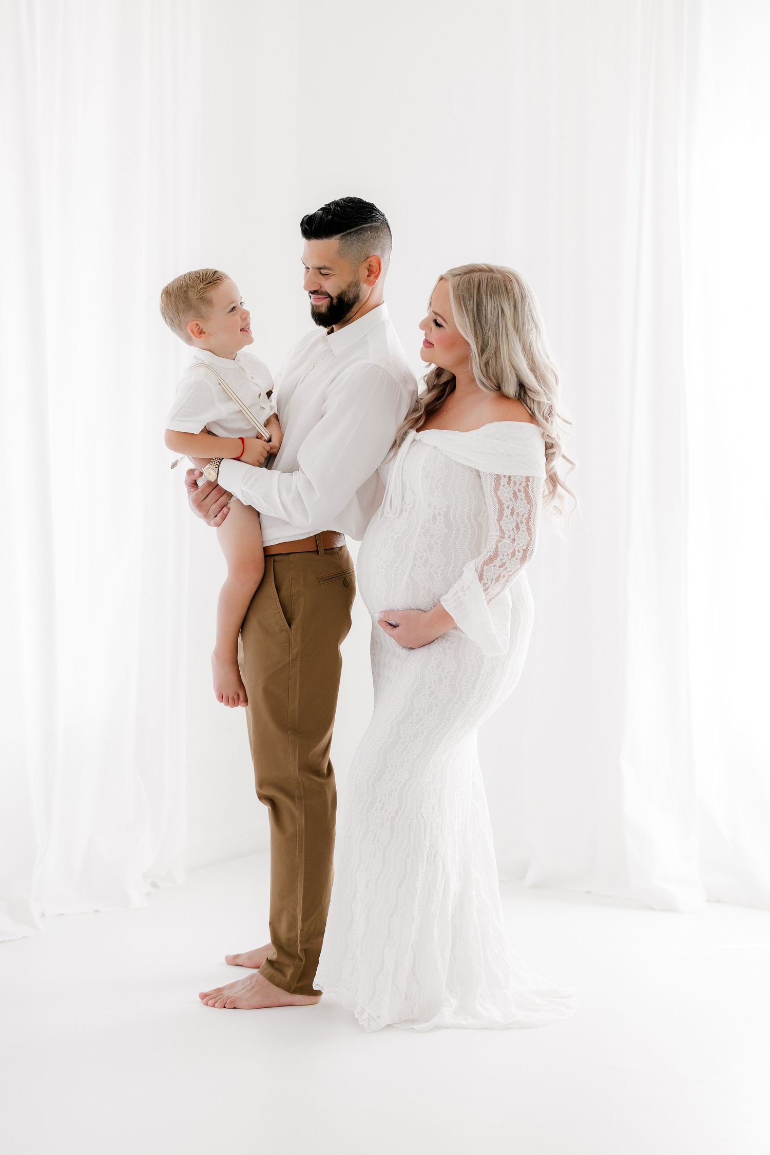 Three tender family moments captured in white studio portraits showing parents embracing their small child.