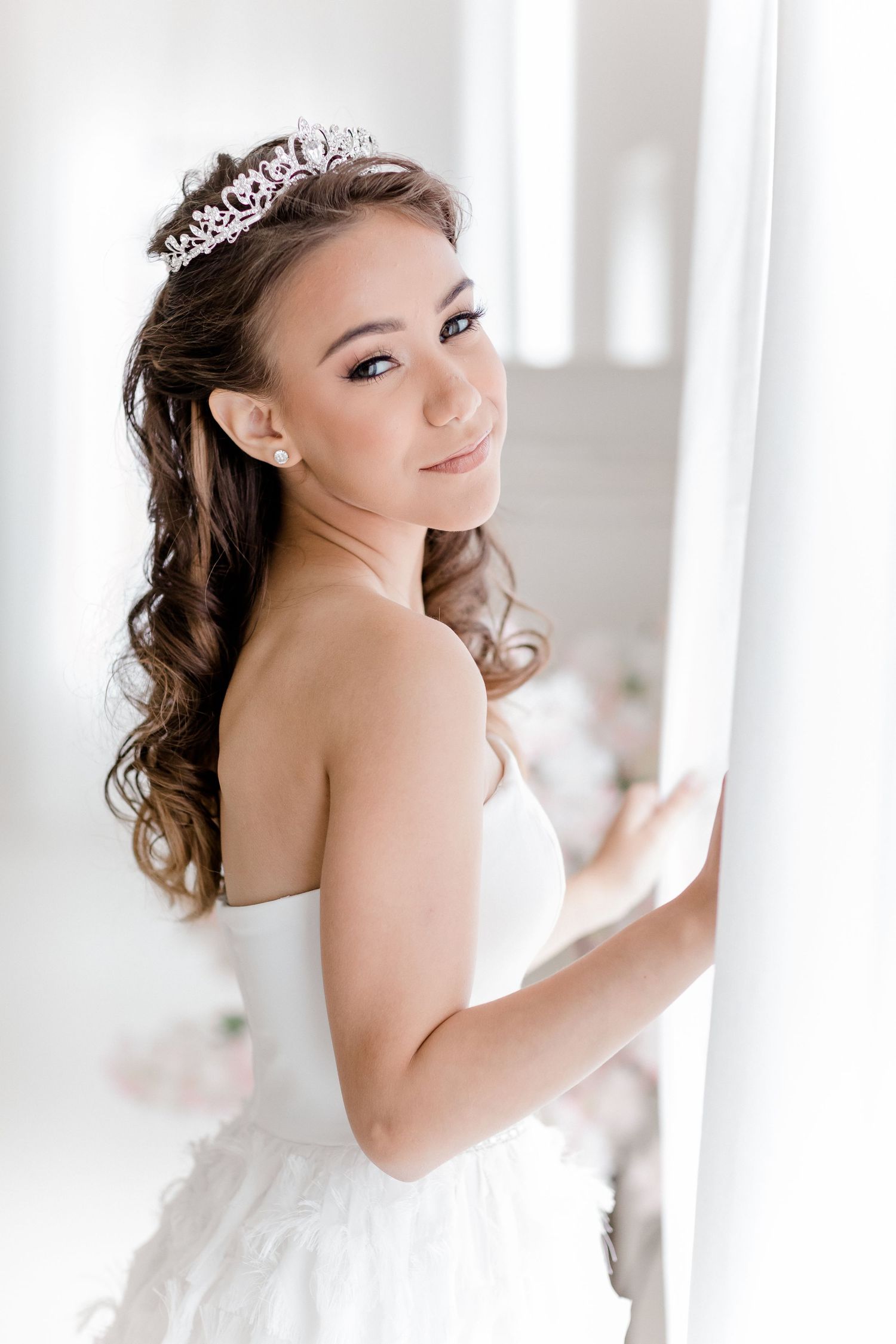 Three elegant bridal portraits showing a white wedding dress and sparkling tiara against a bright interior background.