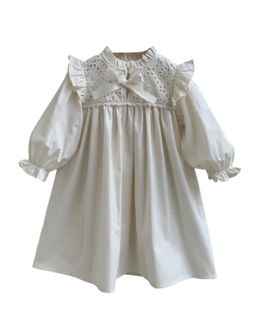 Ivory girls dress with lace eyelet yoke, bow detail, puff sleeves, and ruffled cuffs.