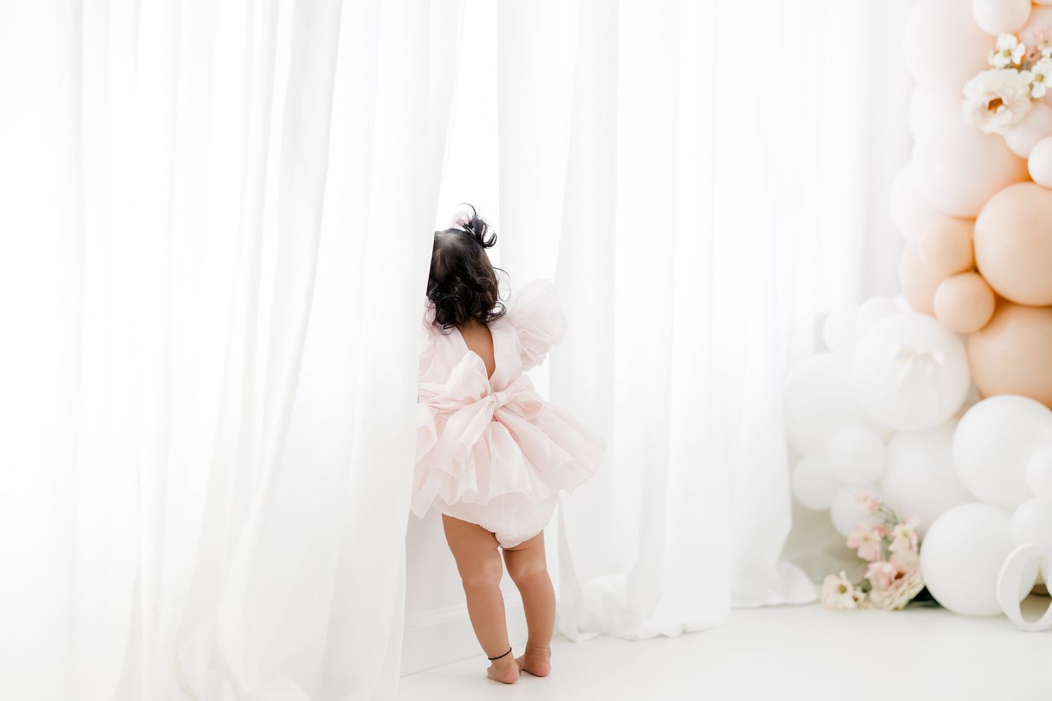A series of dreamy pastel photos featuring soft tulle dresses and balloons against white curtained backgrounds.