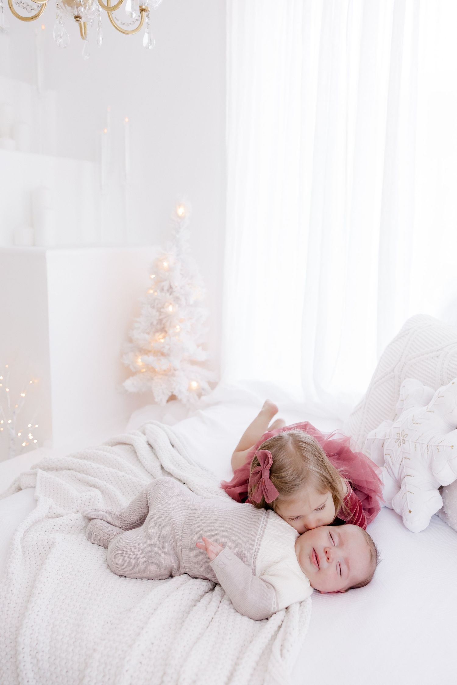 A peaceful scene with soft lighting and holiday decorations in the background.