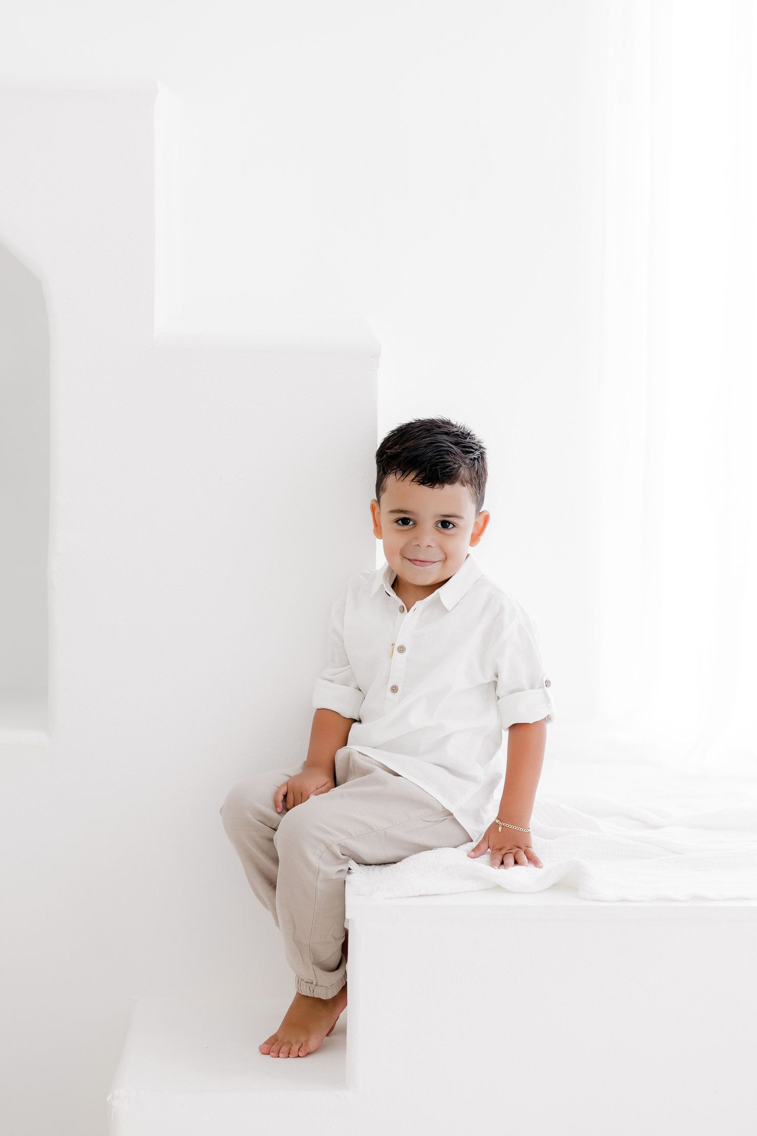 Clean minimalist white studio portraits with crisp styling and natural lighting.