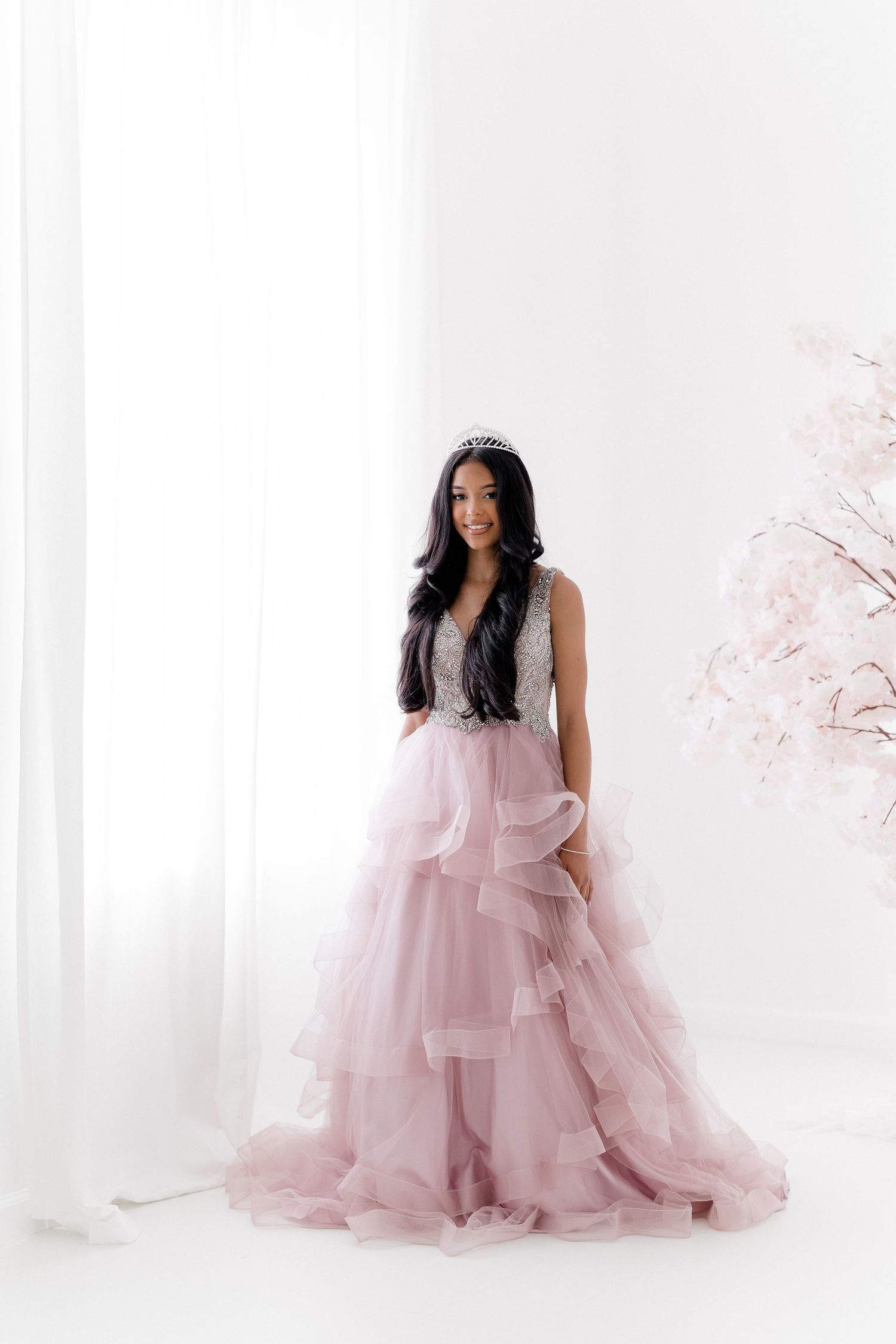 A dreamy portrait series featuring a soft pink tulle gown against a light ethereal background.