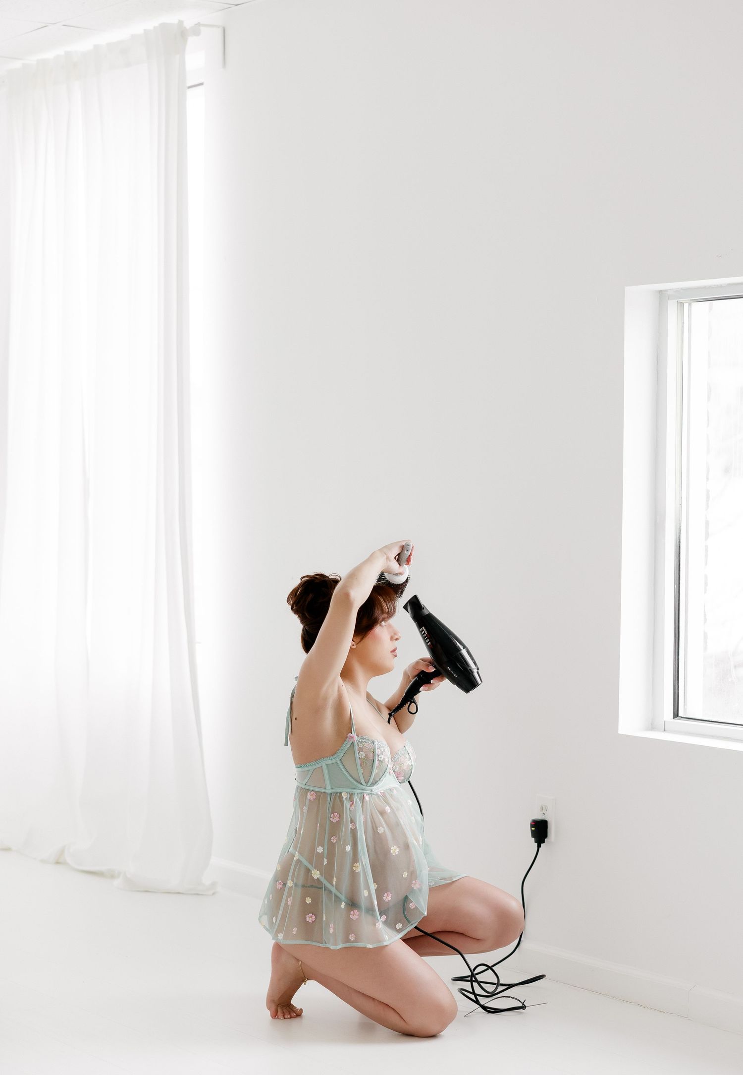 A series of artistic boudoir photographs in a bright white studio with soft natural lighting.