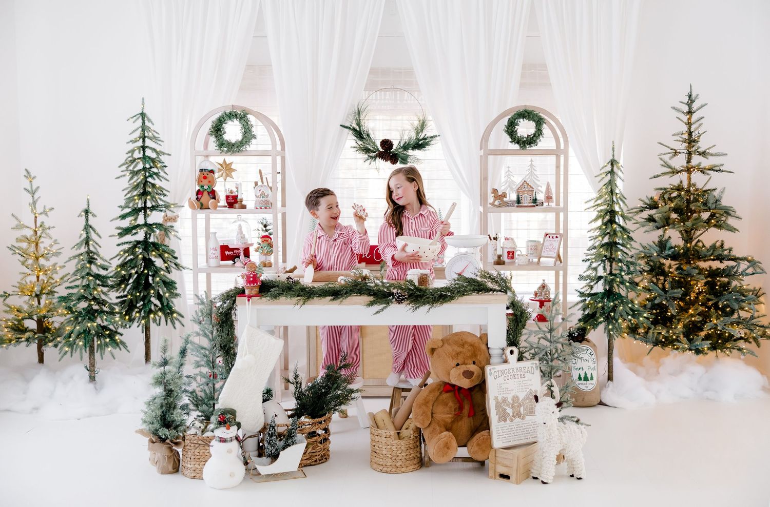 Minimalist Christmas scene with multiple trees, woodland decorations and pink accents.nj holiday mini sessions