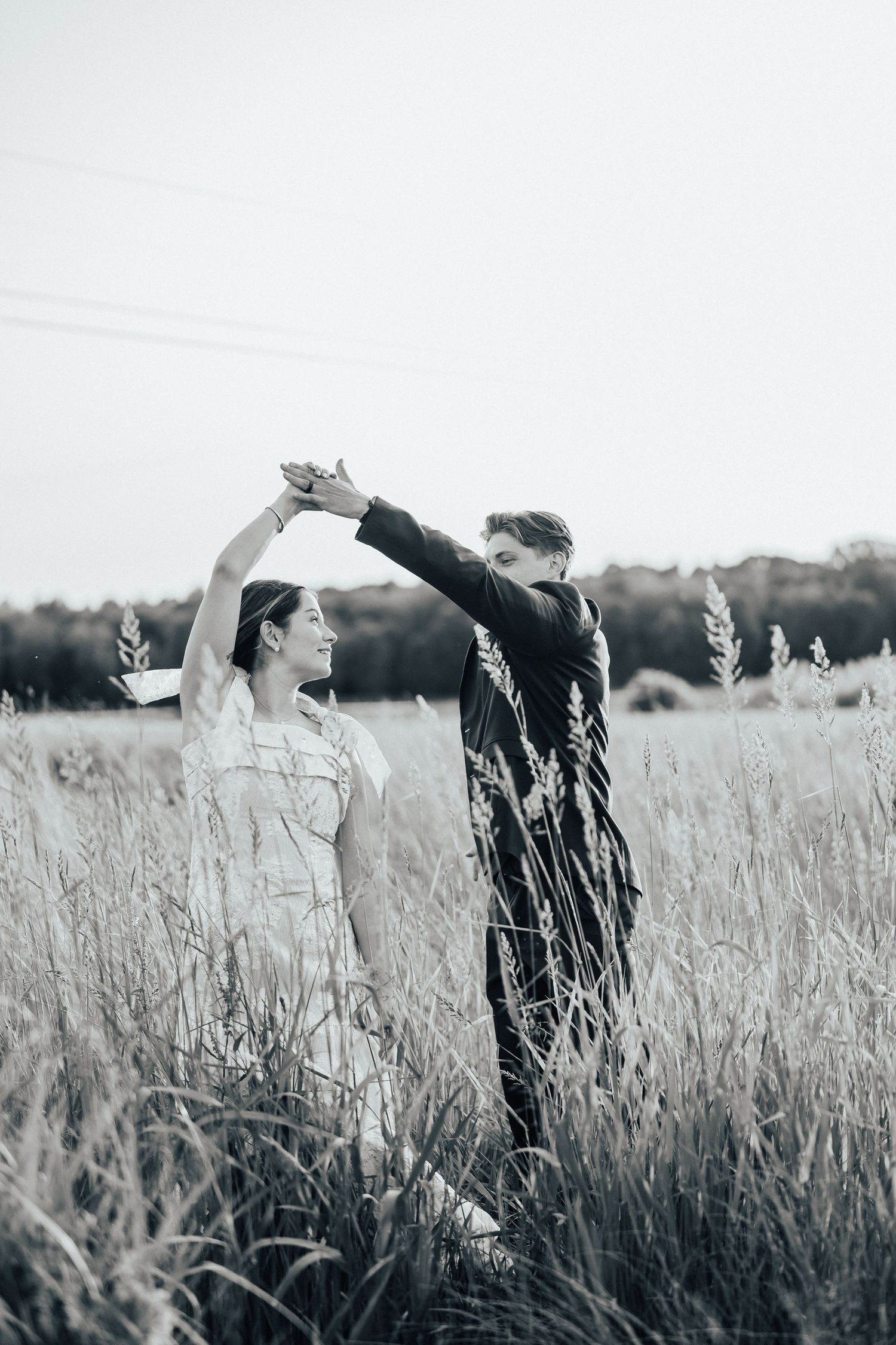 Black and white artistic portrait series showing silhouetted figures in tall grass field reaching upward to the sky.