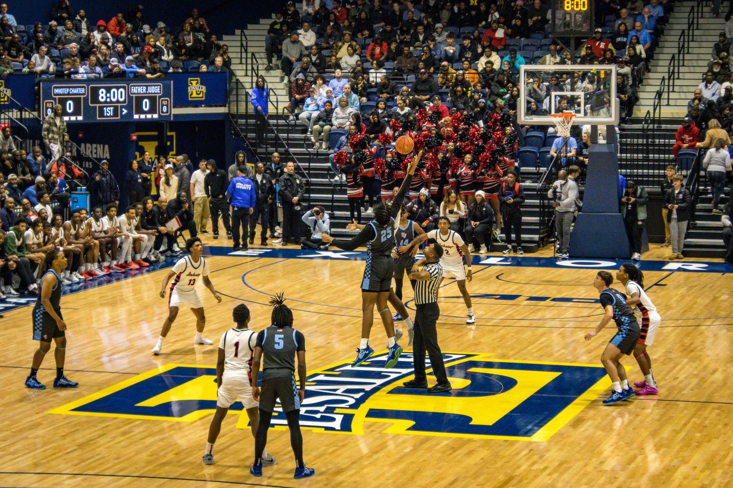 An image of a basketball game's opening tip.