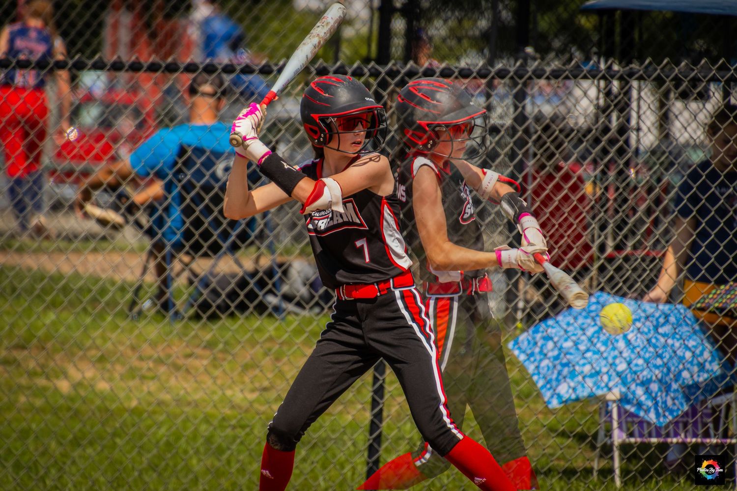 A double exposure image of a softball player hitting.