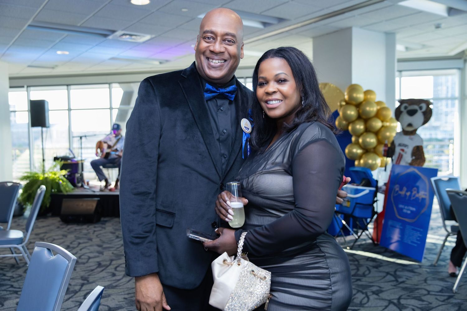 Professional networking event with people mingling and socializing in a modern office space.