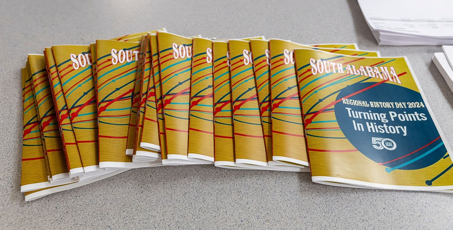 Stack of yellow educational or training manuals arranged in neat row.