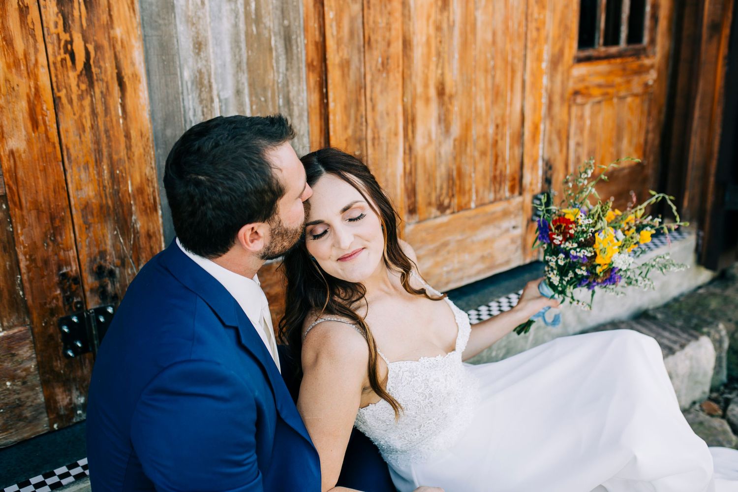 A romantic wedding photoshoot showing tender moments between a couple against a rustic wooden wall background.