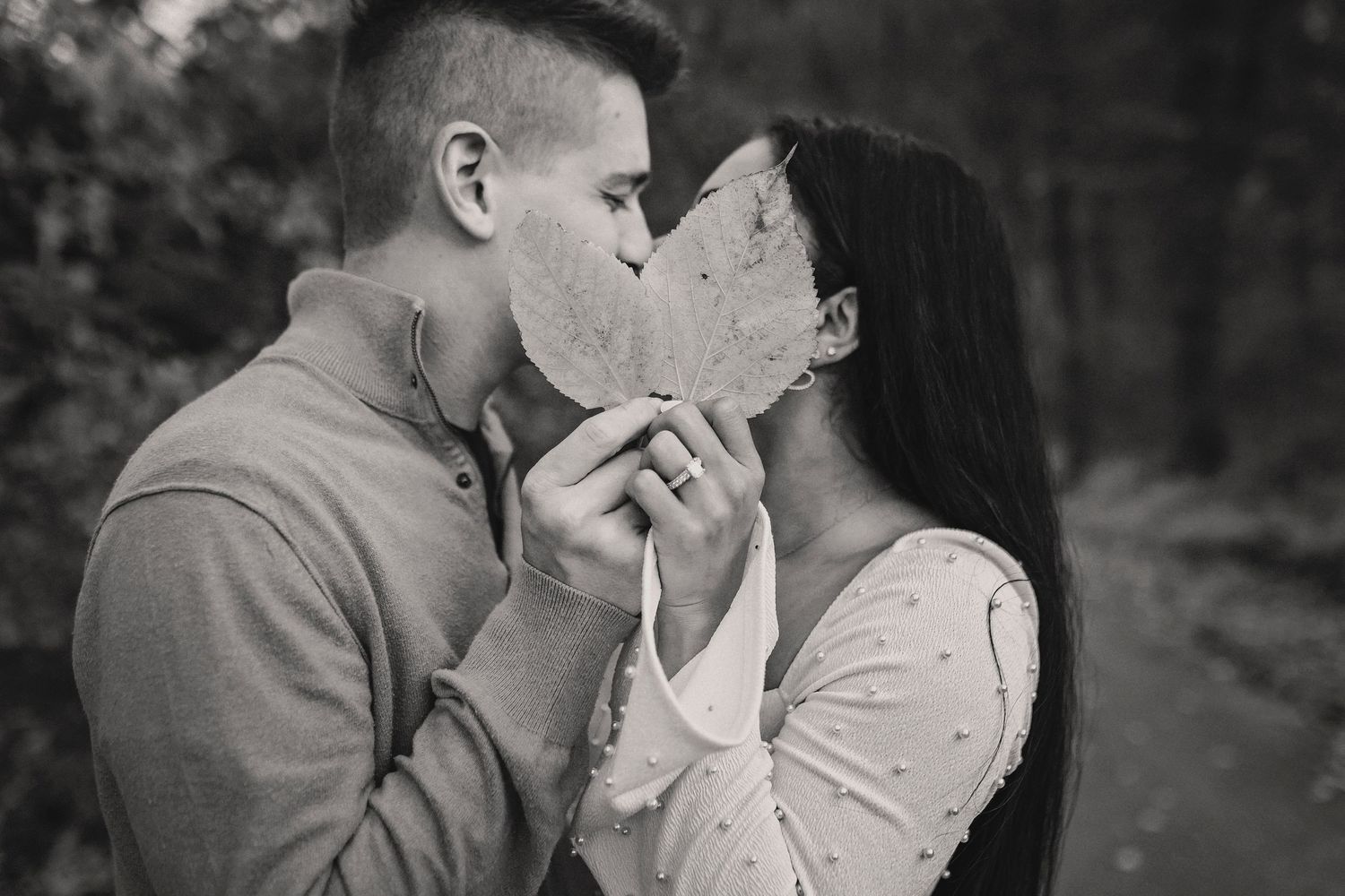 Black and white romantic photo collage showing tender moments of love and affection between two people outdoors.