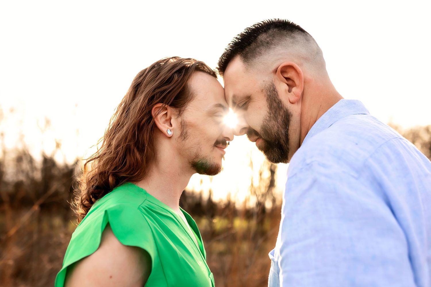 Intimate portrait of male couple nose-to-nose in Springfield Missouri at golden hour.