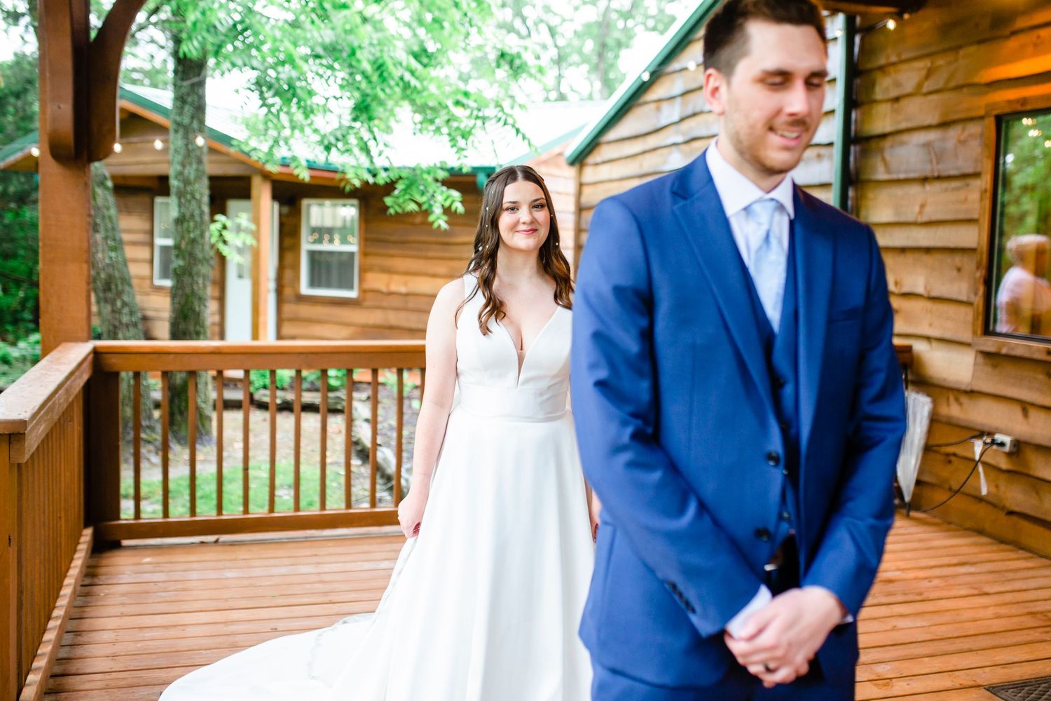 First look moment between couple on rustic wooden cabin porch.