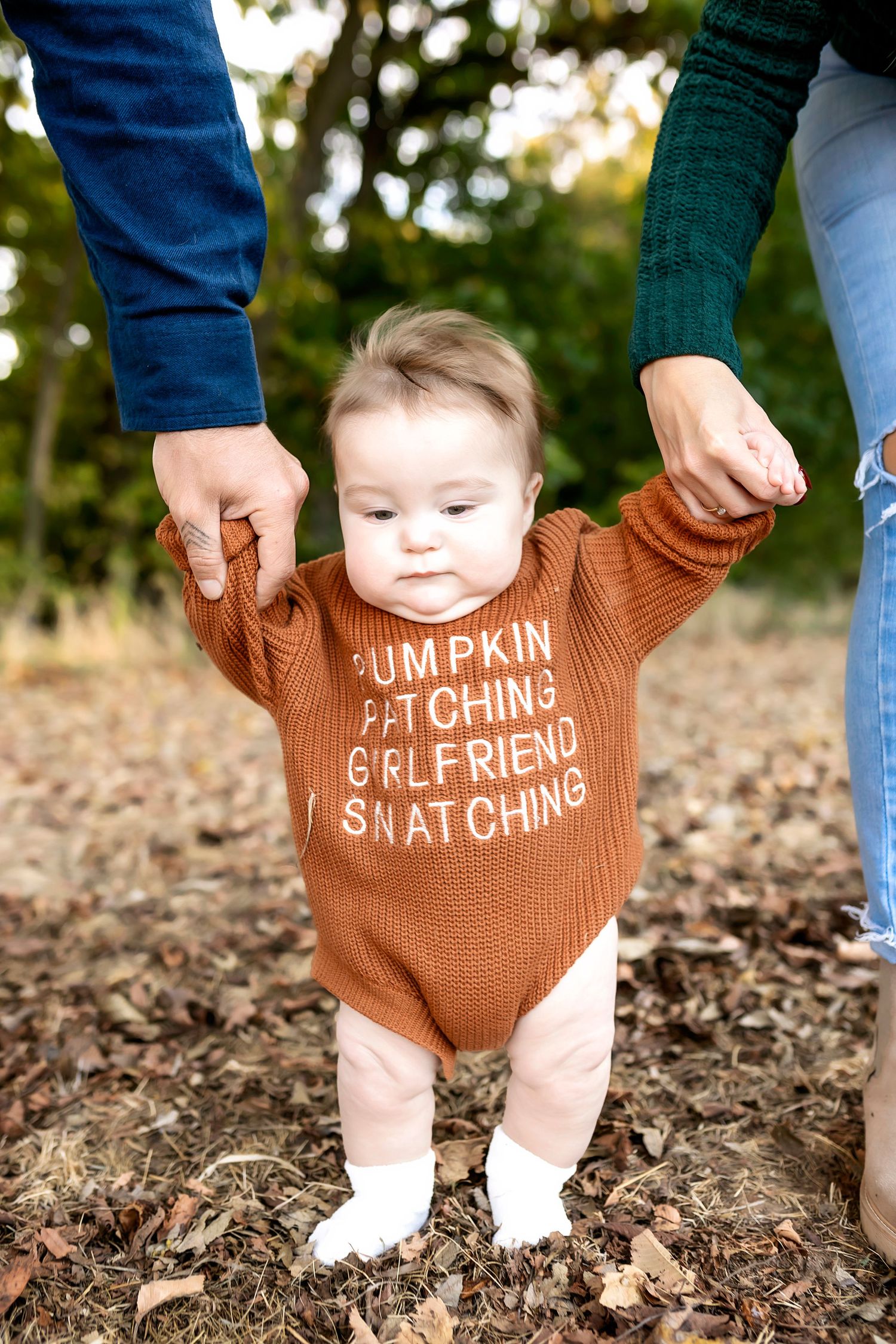 Baby wearing brown sweater with 