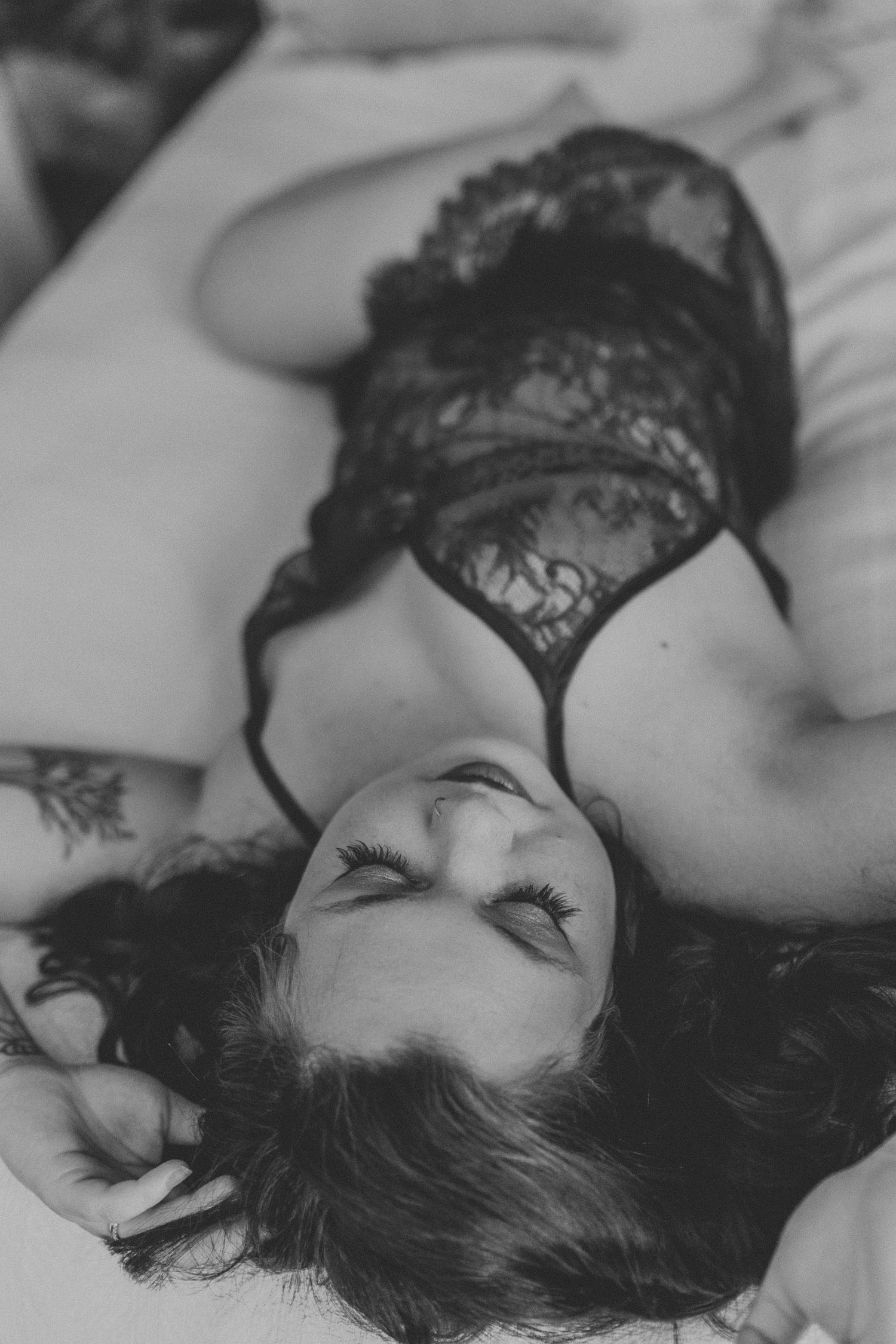 A series of black and white close-up shots showing a person with dark hair resting peacefully against white bedding.