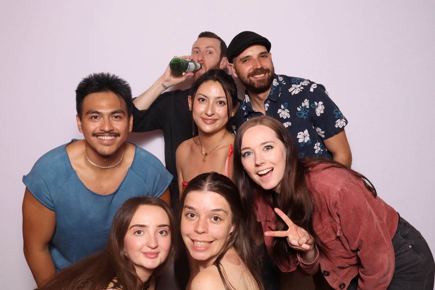 A group of young people are posing for a photo booth picture