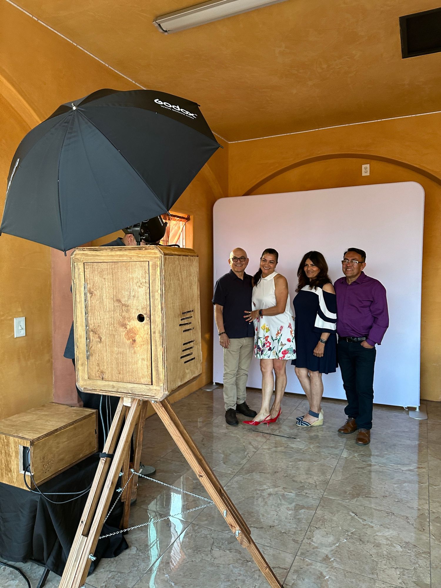 A photo booth set up and a two couples pose for a picture