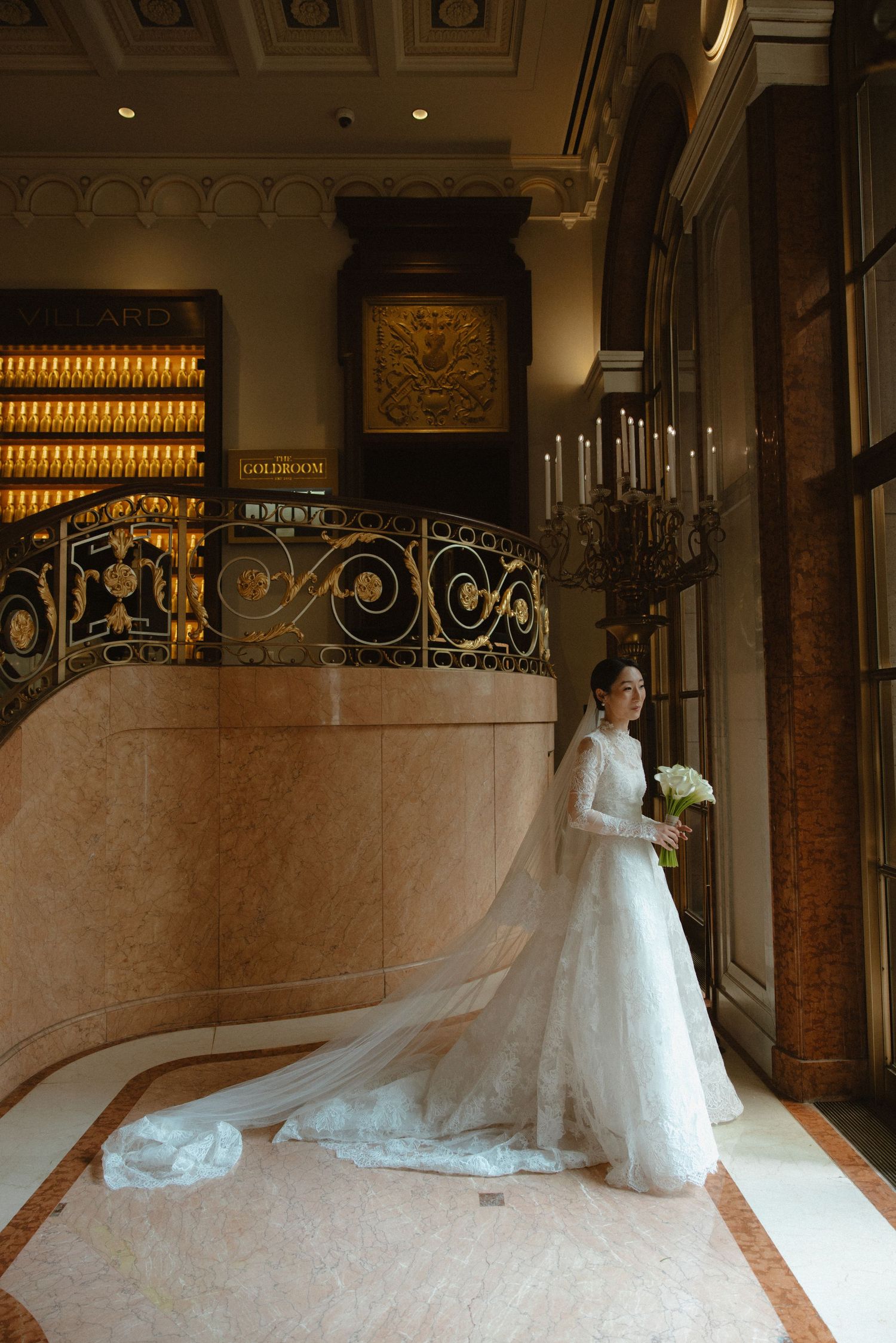A dramatic bridal portrait series in an elegant venue with a flowing white dress train.