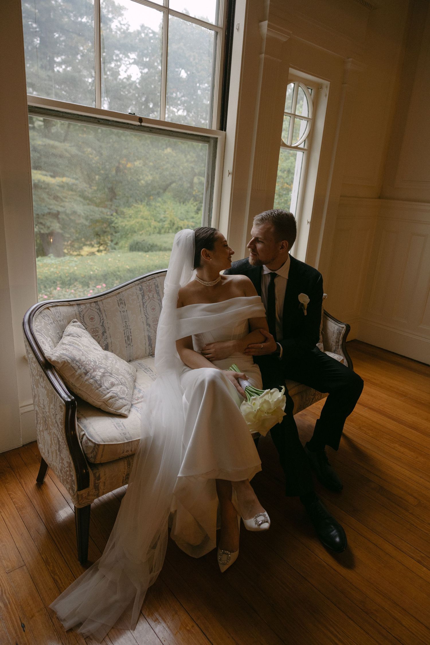 Romantic wedding sequence by large windows in vintage indoor setting.