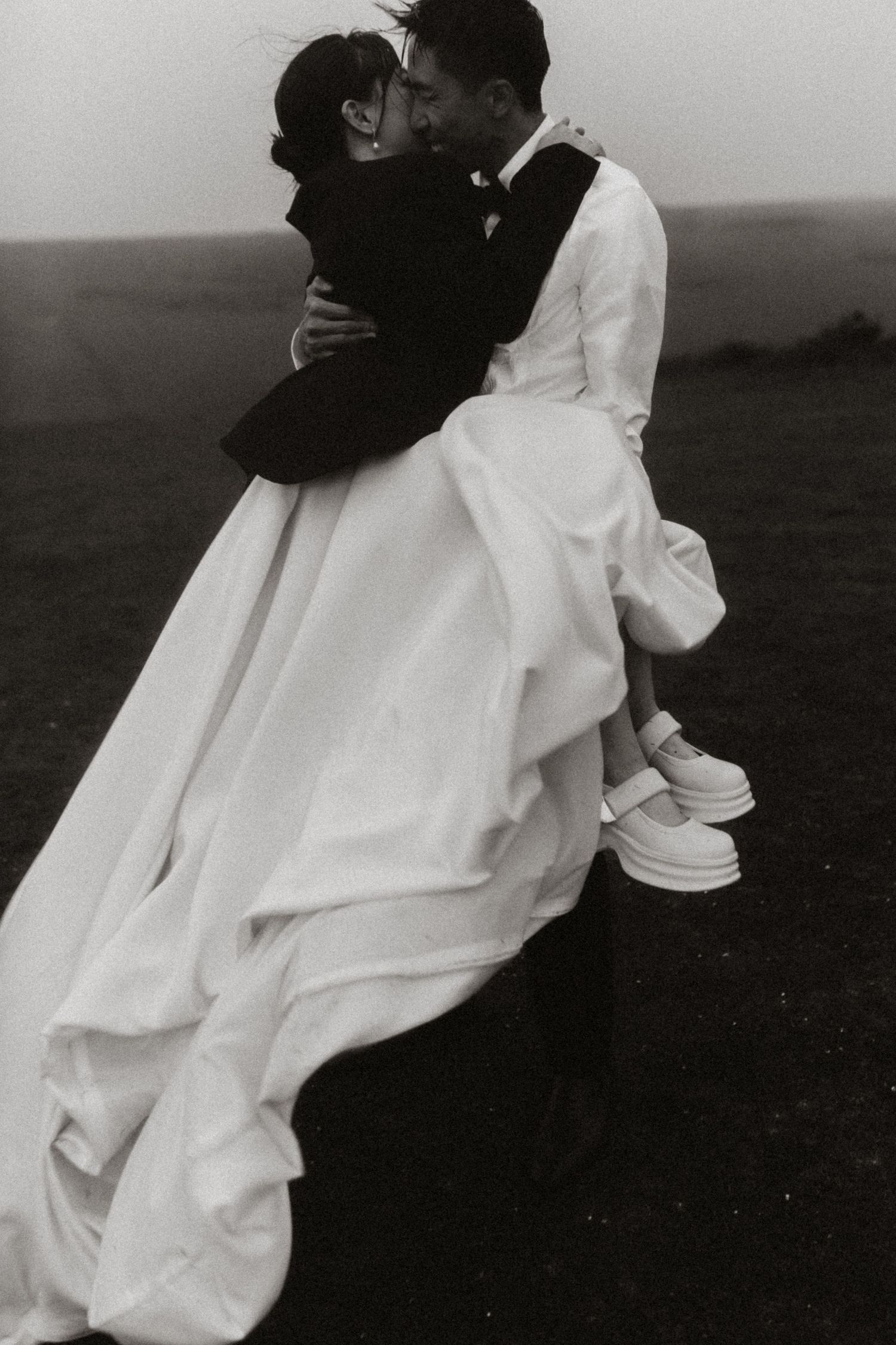 Sequence showing couple in wedding attire embracing against minimalist background.