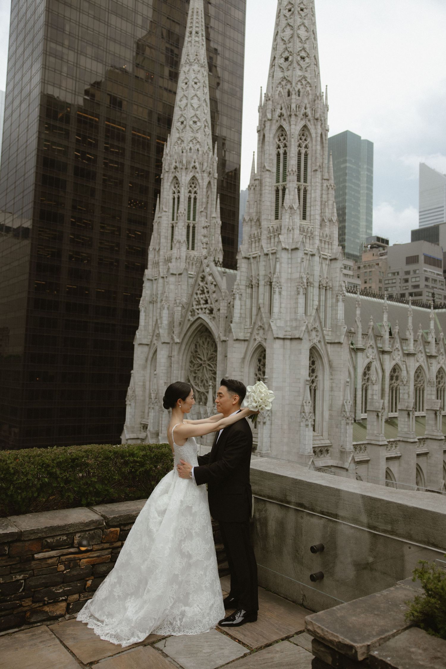 A wedding photoshoot with St. Patrick's Cathedral and Manhattan skyscrapers in the background.