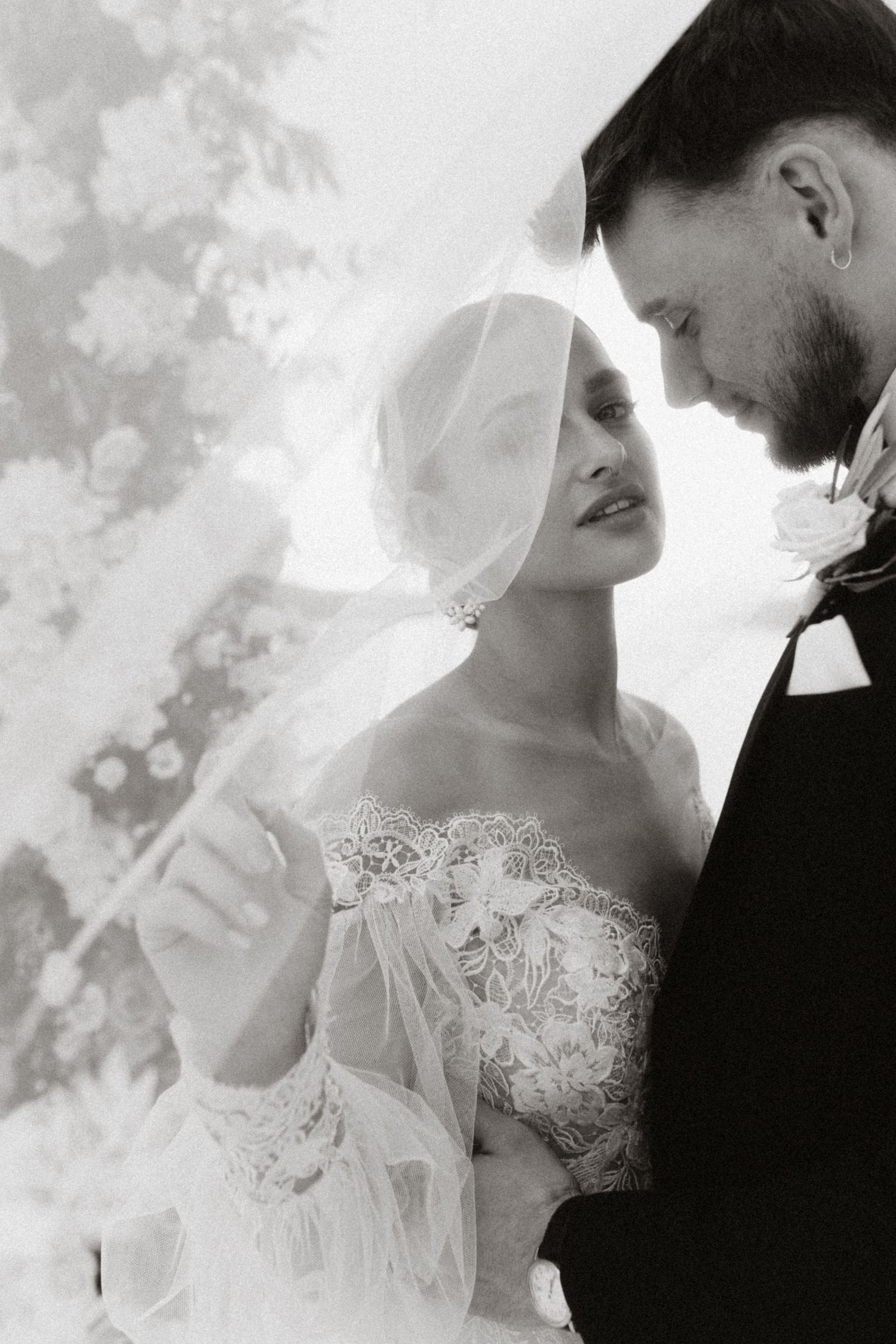 An intimate black and white wedding portrait with soft dreamy lighting.