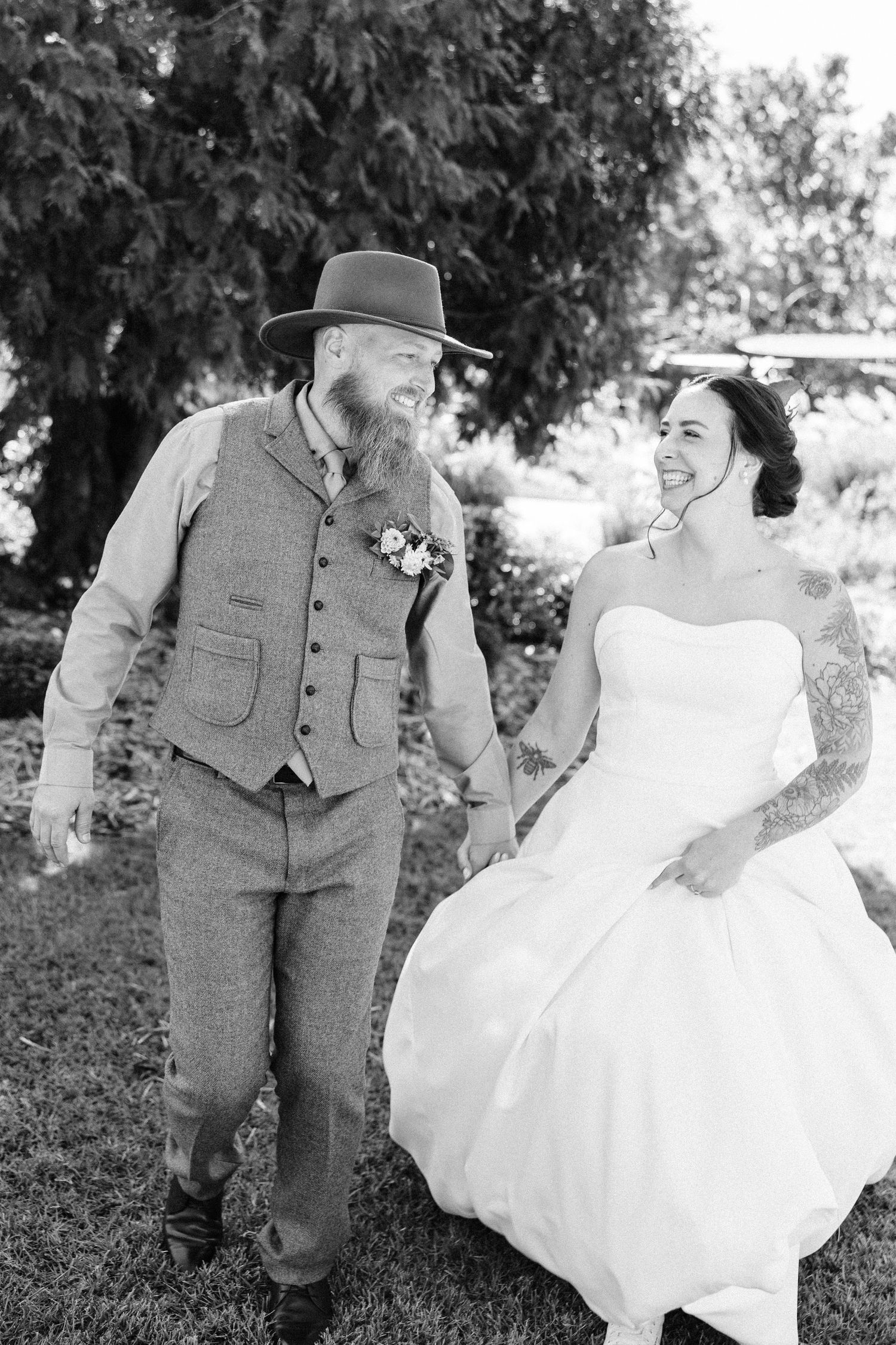 Black and white wedding photos showing joyful moments between a couple in vintage-inspired attire.