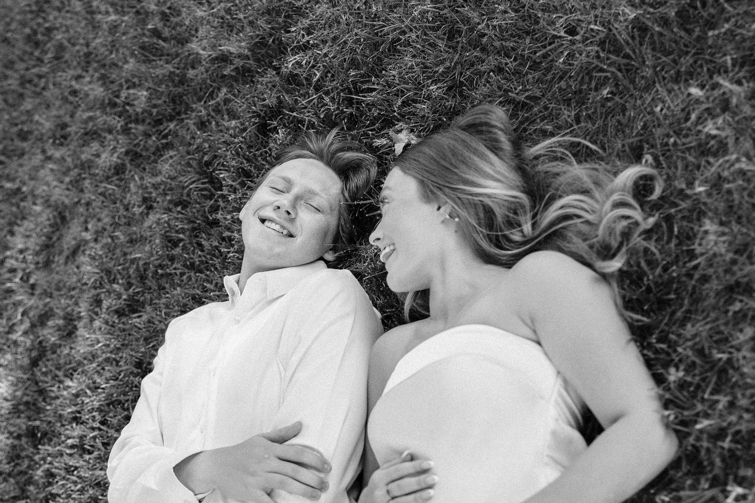 A series of black and white romantic photos showing couples embracing in a natural outdoor setting.