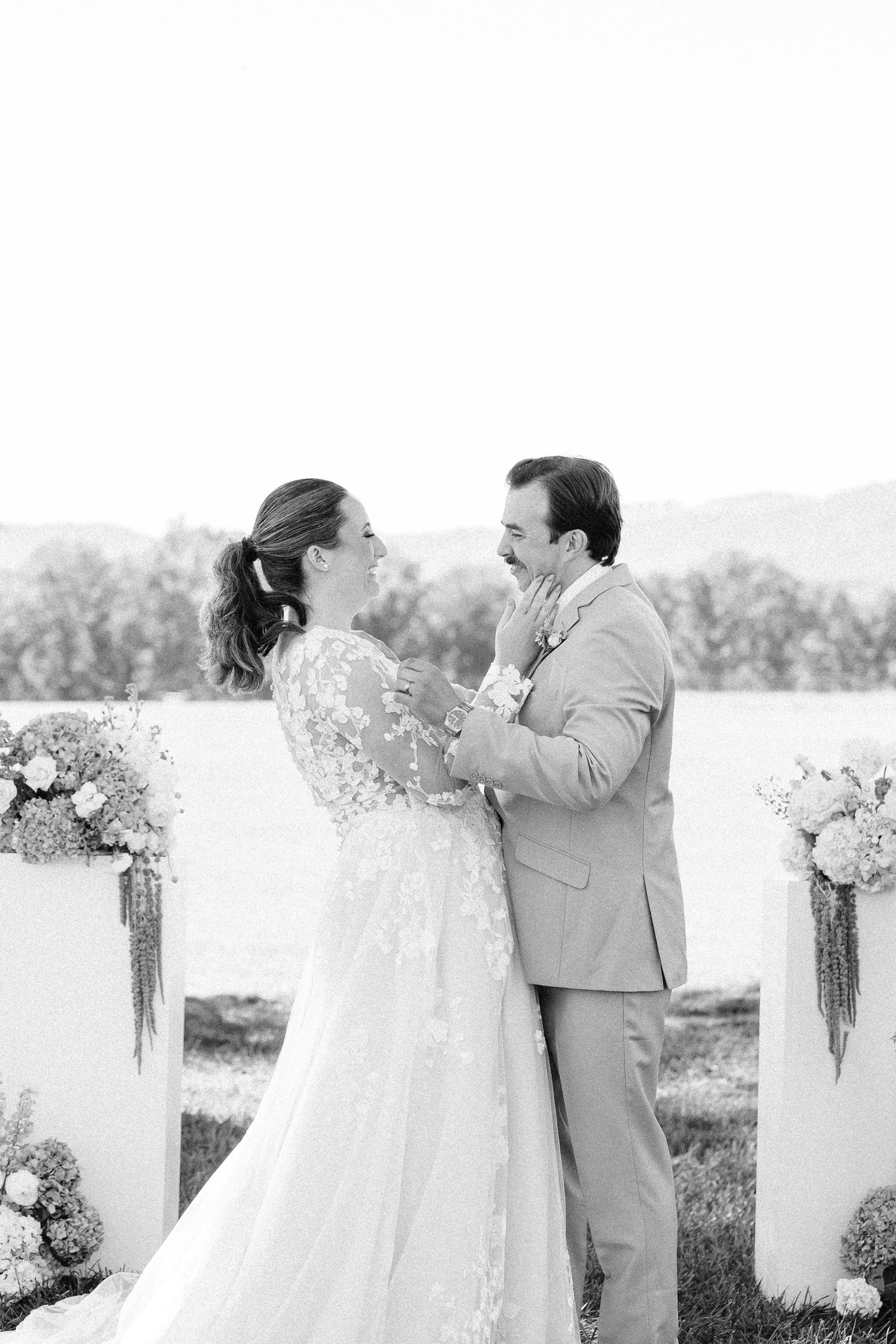 Wedding couple shares emotional first look moment during outdoor ceremony.