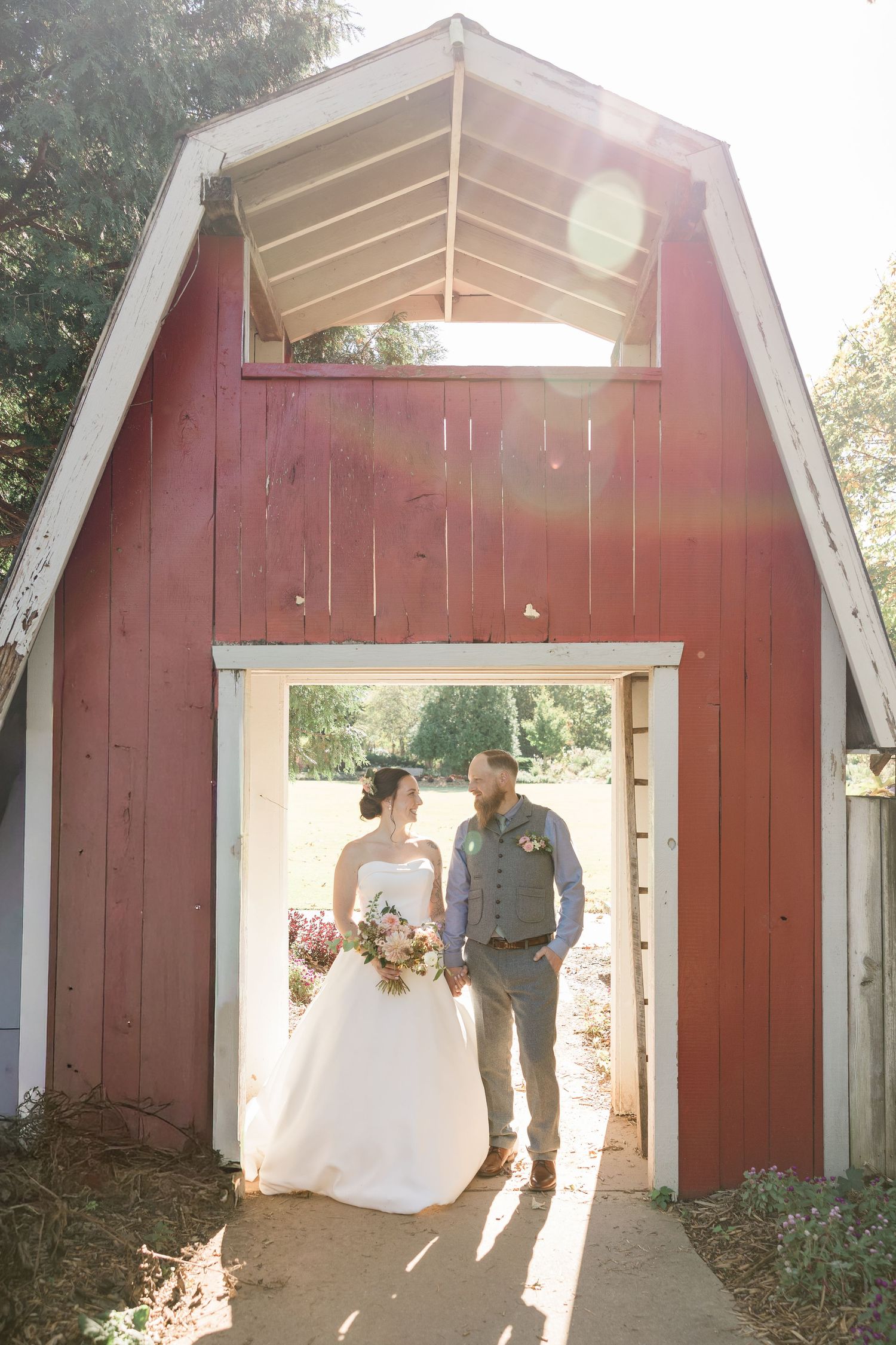 A wedding photoshoot sequence captured in front of a rustic red barn with natural sunlight streaming through.