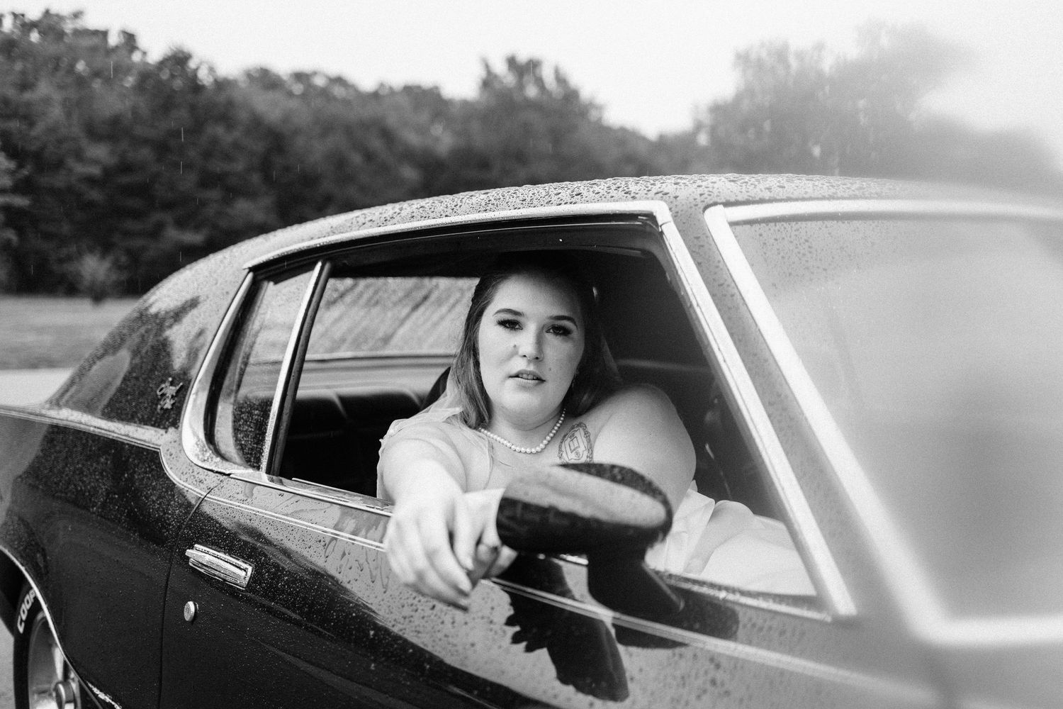A series of black and white photos showing people looking out of car windows on a sunny day.