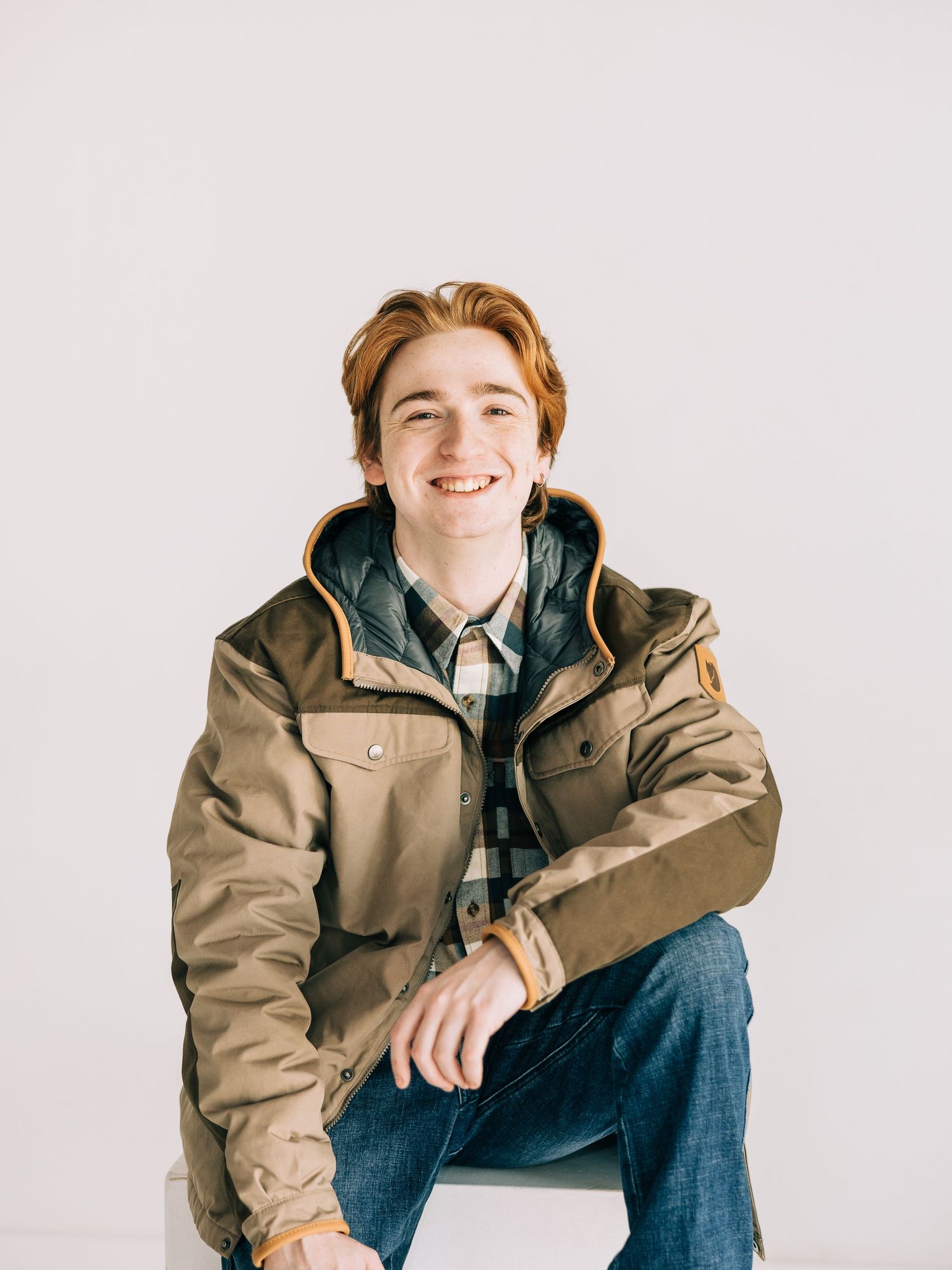 A person in a tan jacket and jeans poses casually against a white background in a series of lifestyle shots.