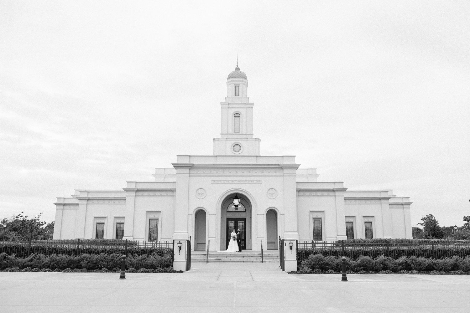 A series of five identical white church buildings with steeples shown in a repeating panoramic view.