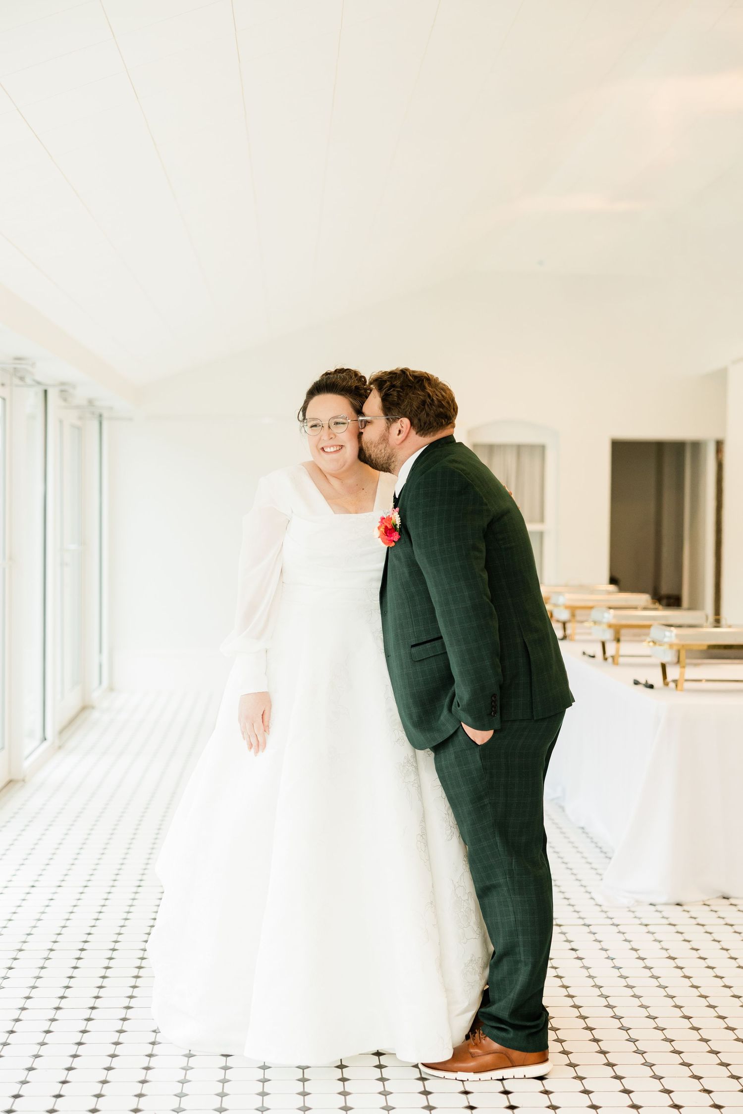 A romantic wedding moment captured in sequence on a white tiled floor with elegant interior lighting.