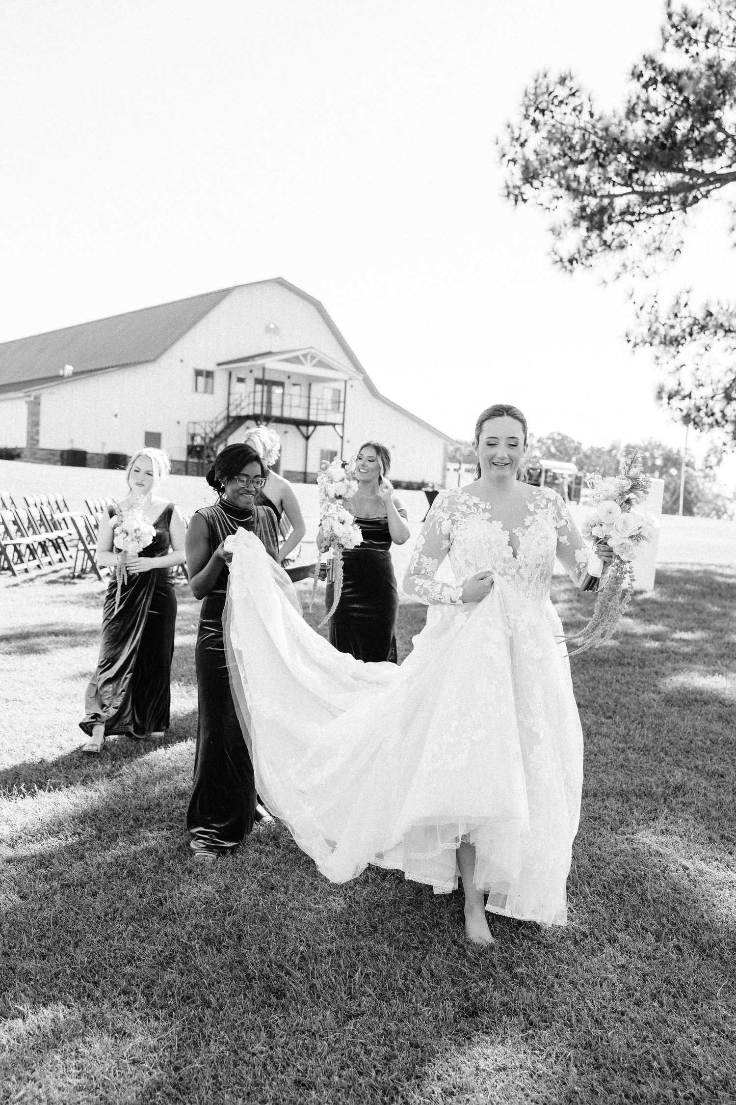 A bride's white wedding dress flows gracefully in the wind during an outdoor photo session.