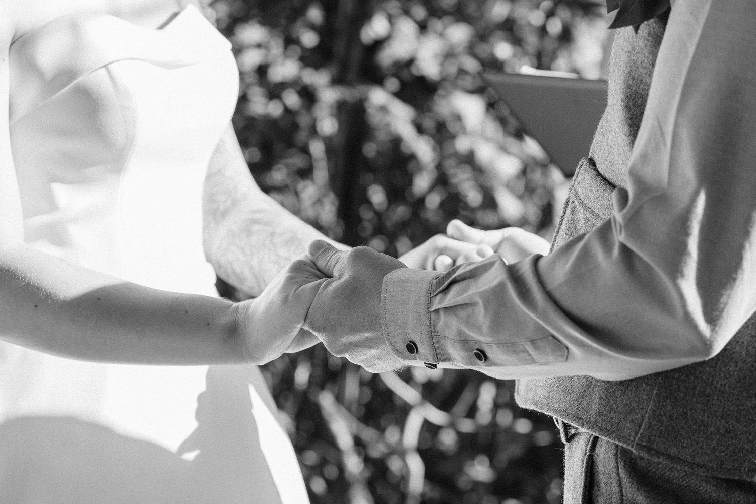 Black and white photograph of a couple dancing together at a wedding reception.