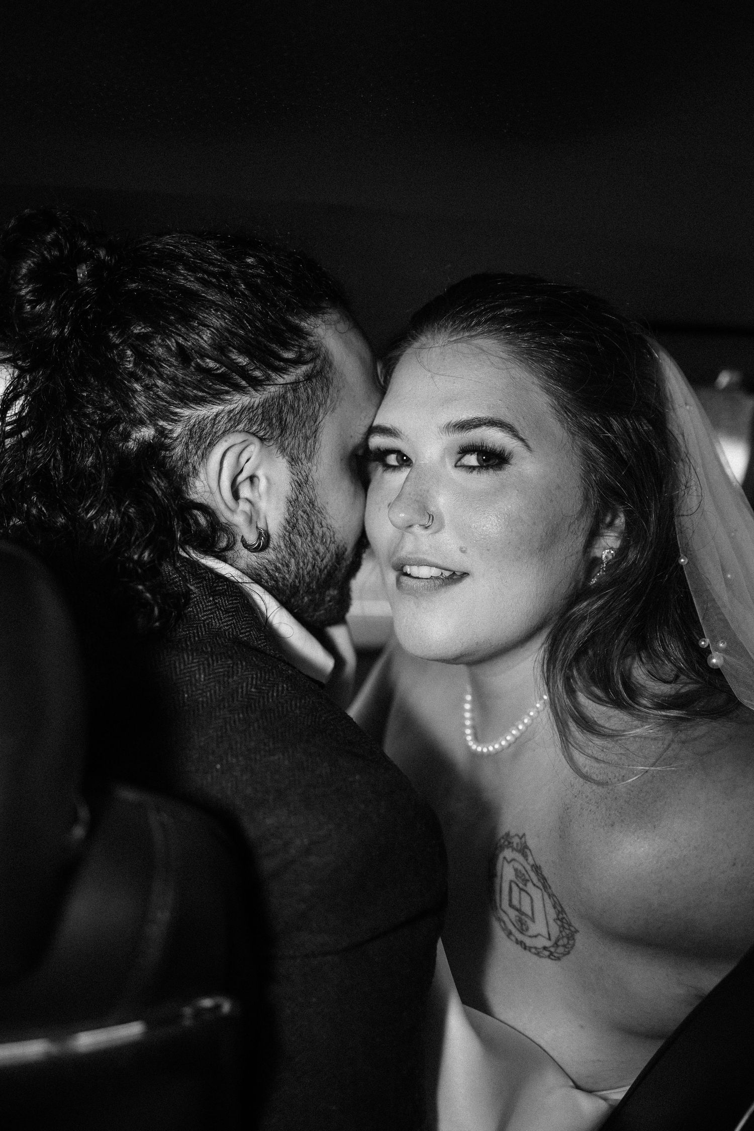 Dramatic black and white close-up photographs showing intimate moments between a couple at an evening event.
