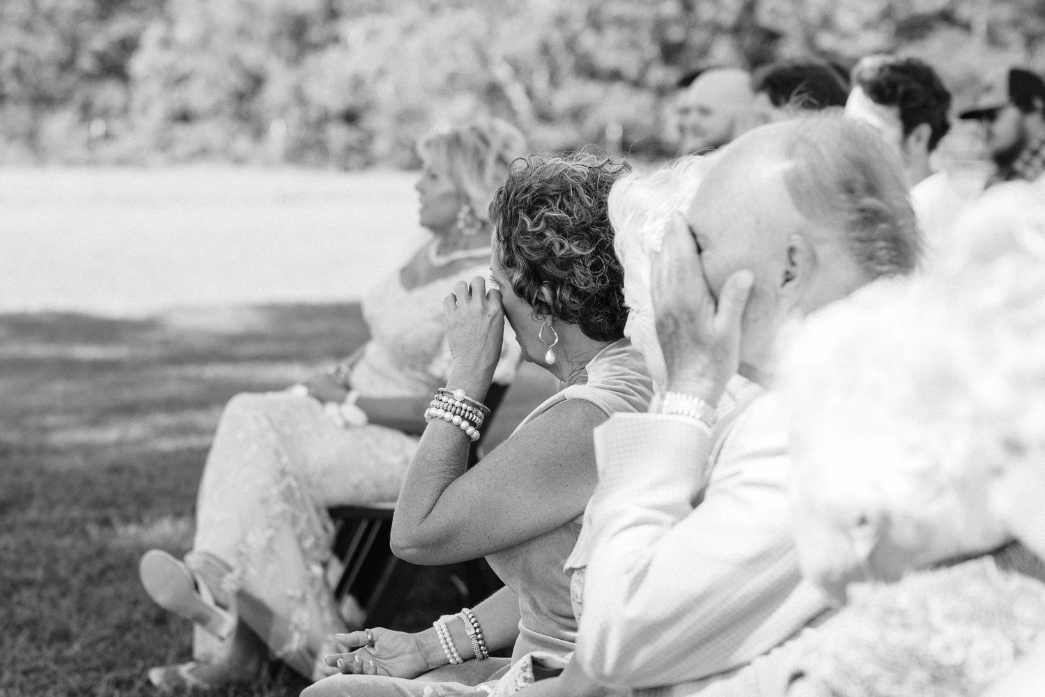 Candid moments of wedding party laughter and celebration on grass.