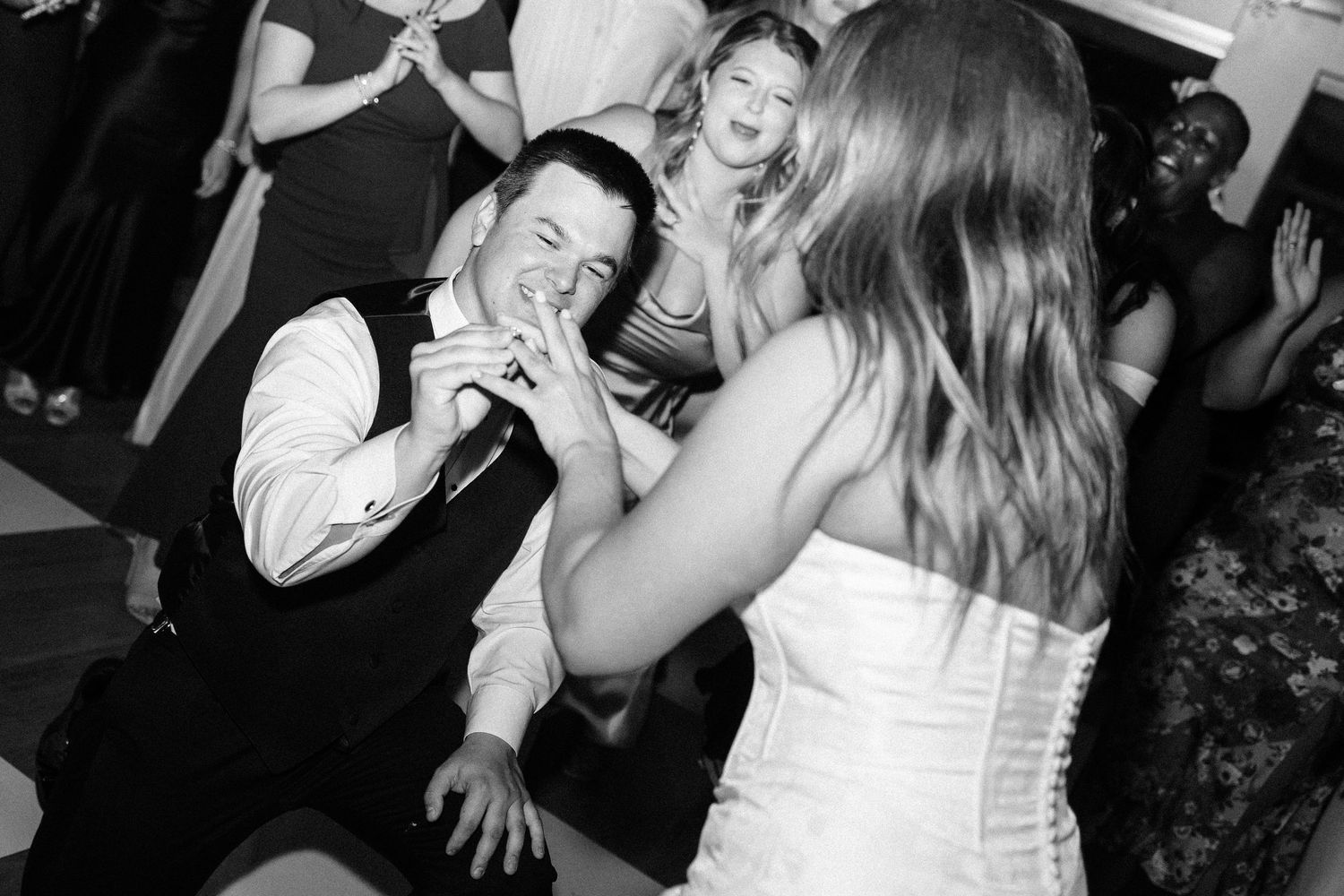 Black and white photos show people dancing and celebrating at a lively party or reception.