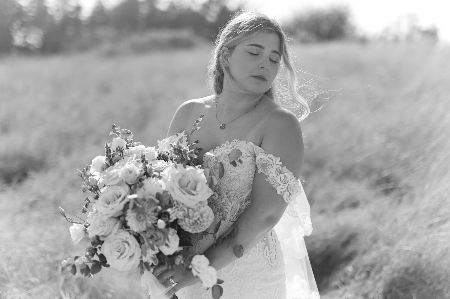 Black and white wedding portraits with elegant floral bouquet in natural setting.