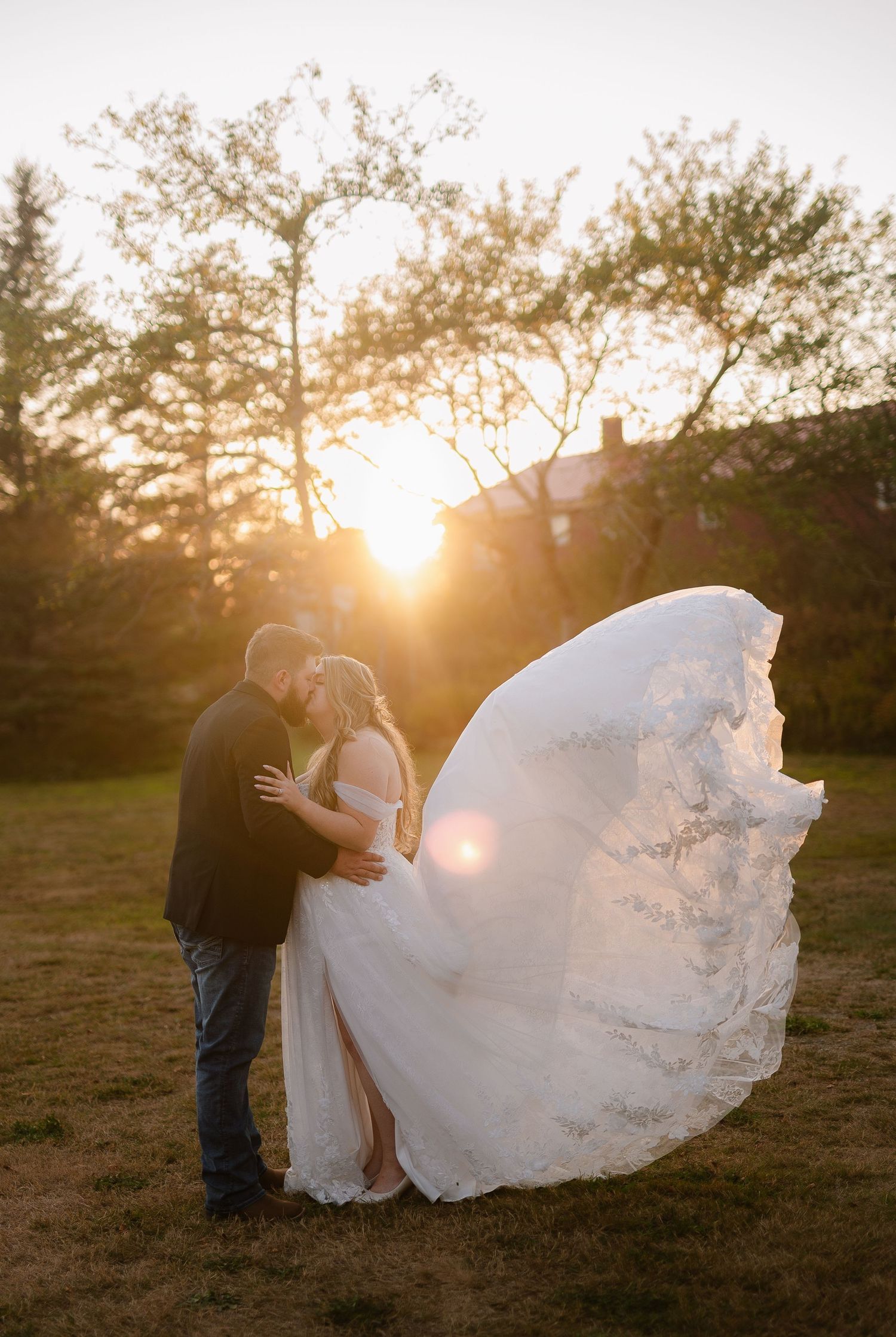 Romantic sunset photoshoot with flowing white wedding dress catching the golden light.