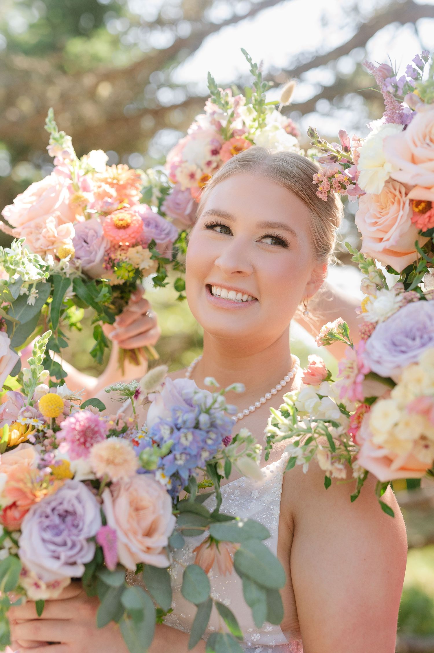 Pastel bridal bouquet with peach, lavender, and cream flowers creates a romantic spring garden look.