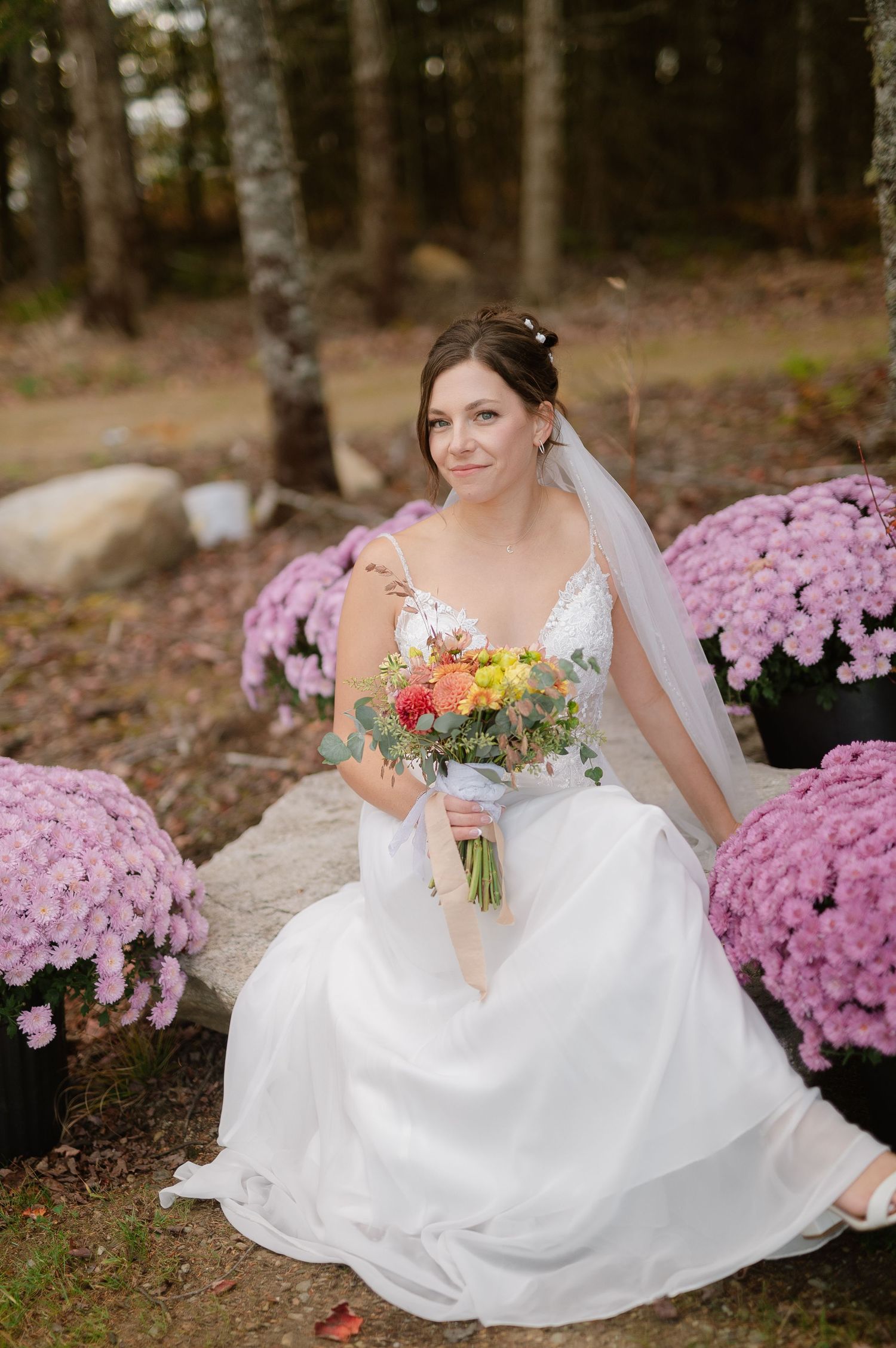 White wedding dress and pink chrysanthemums create a romantic autumn scene.