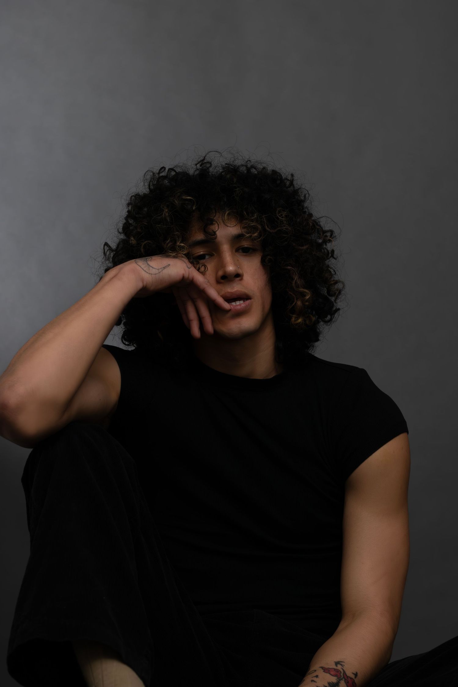 Male model in studio editorial portrait, professional Sioux Falls photographer capturing fashion, mood, and creative lighting for branding.