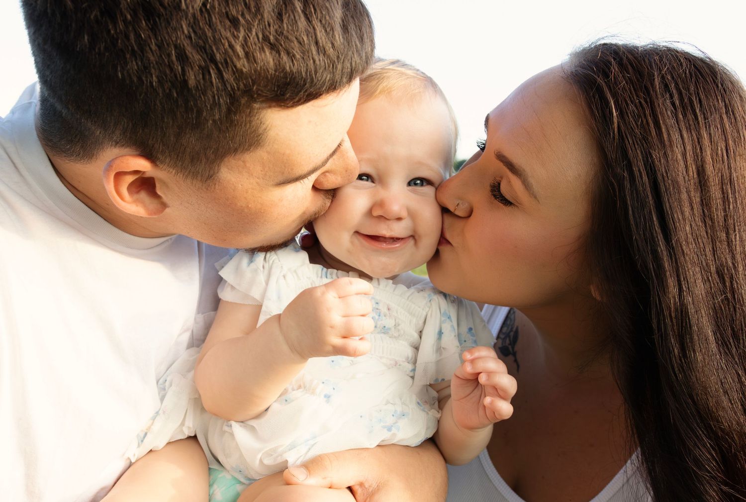 Parents holding children close during a portrait session, photographed by Sioux Falls professional family photographer Sixtwentytwo Images.